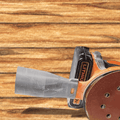 Sanding disc with a glove on a wooden surface