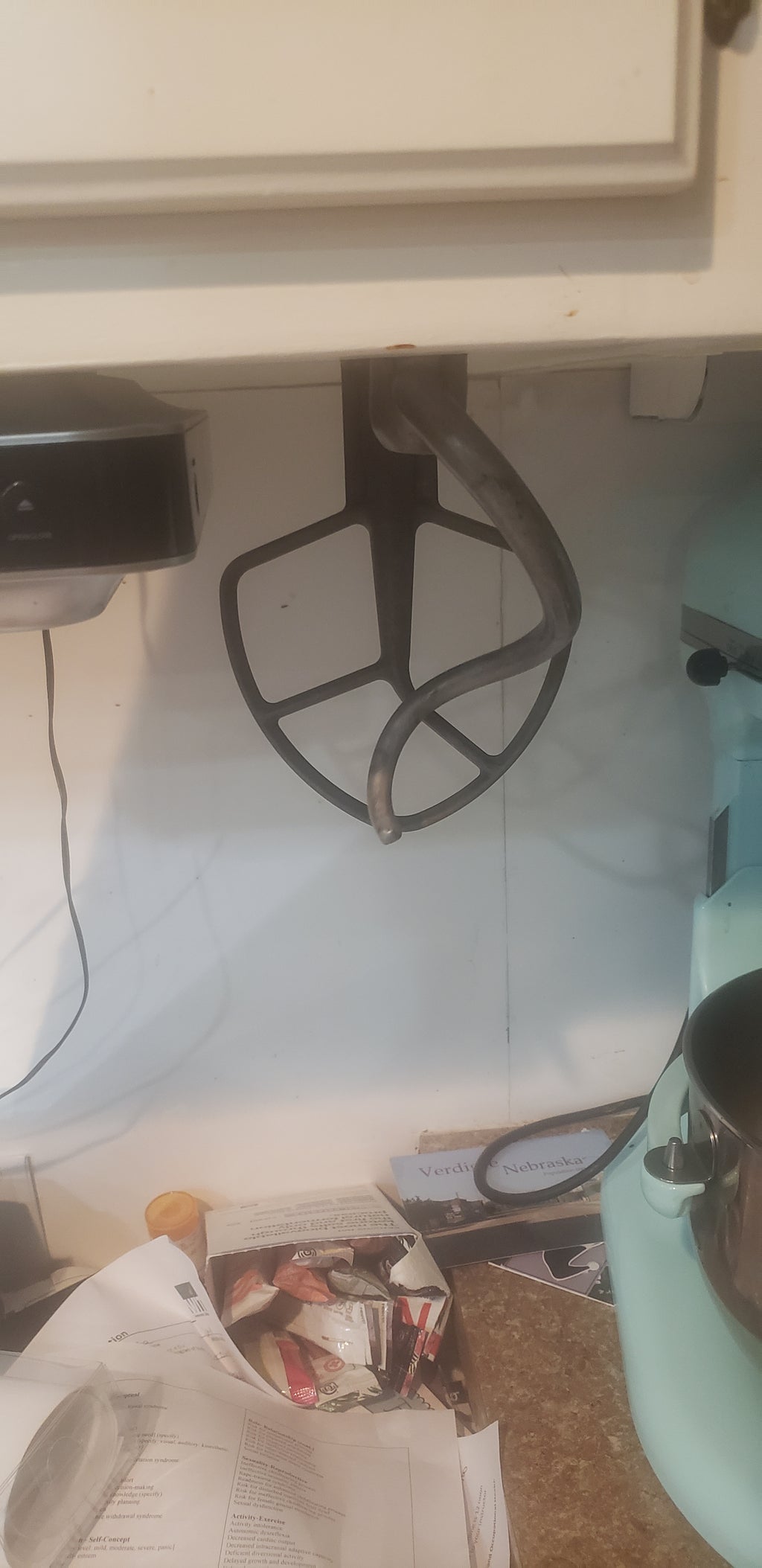 kitchen aid mixer padels hanging on cabnet with adaptor