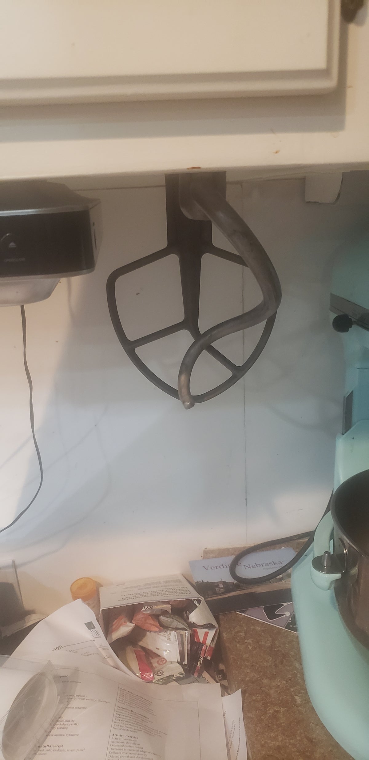 kitchen aid mixer padels hanging on cabnet with adaptor