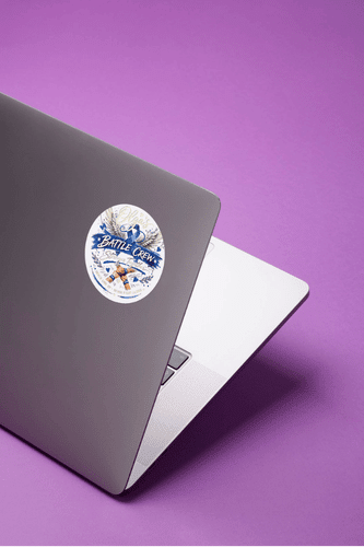 Olga Battle Crew UV DTF Decals sticker on laptop featuring a bold blue cancer awareness ribbon.