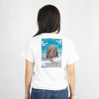 Back of a white T-shirt featuring a memorial print with a baby photo, name, dates, doves, and In Loving Memory text.