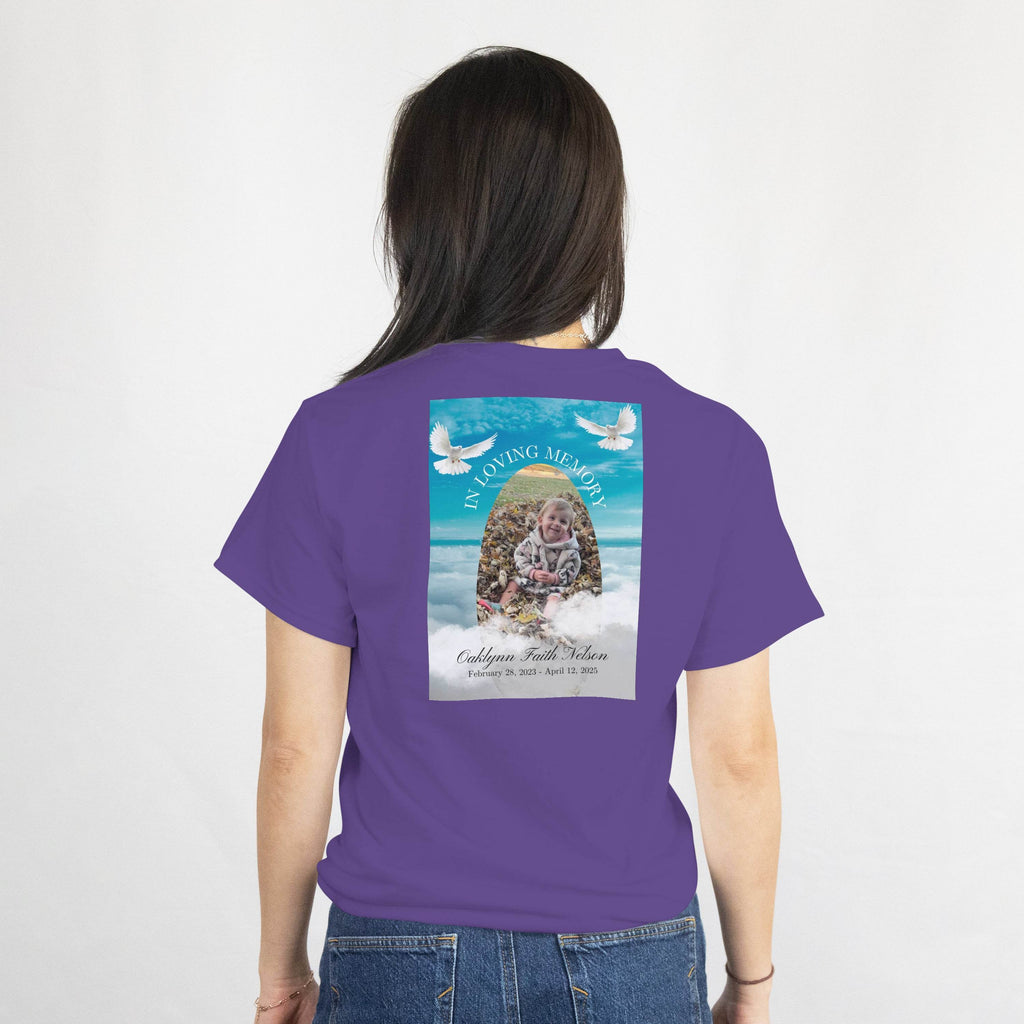 Back of purple memorial tee with photo, name, dates, and two doves in a loving memory design.