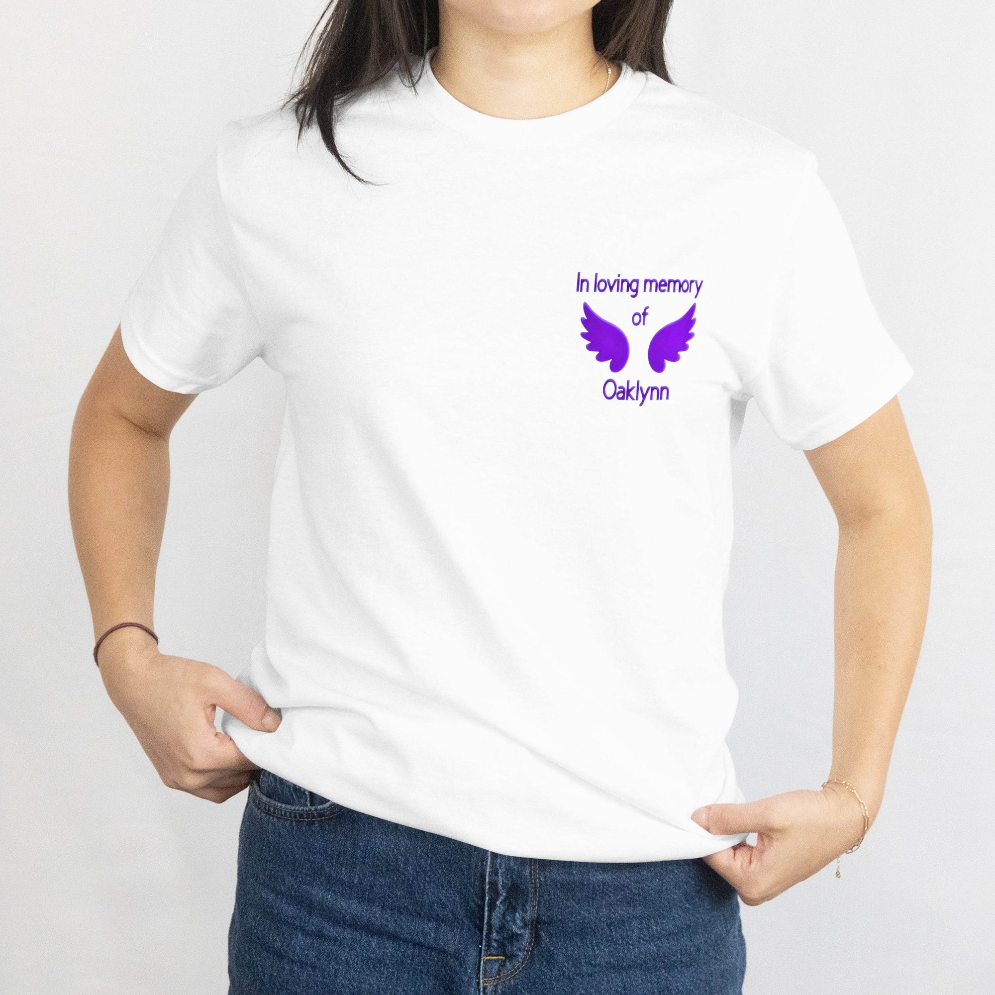 White t-shirt with purple memorial wings design and the text In loving memory of Oaklynn on the chest.
