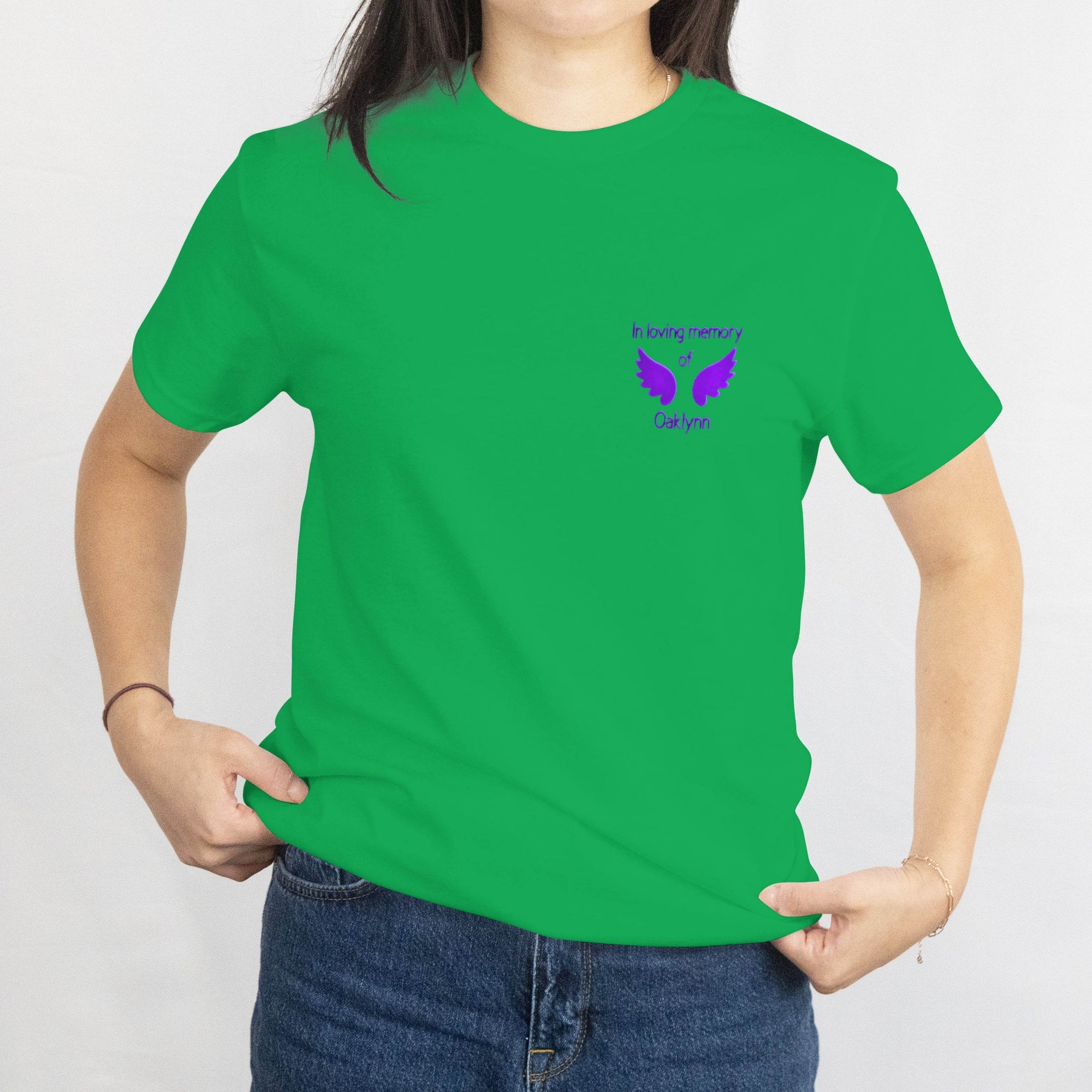 Green memorial tee with purple wings and In loving memory of Oaklynn on the front.