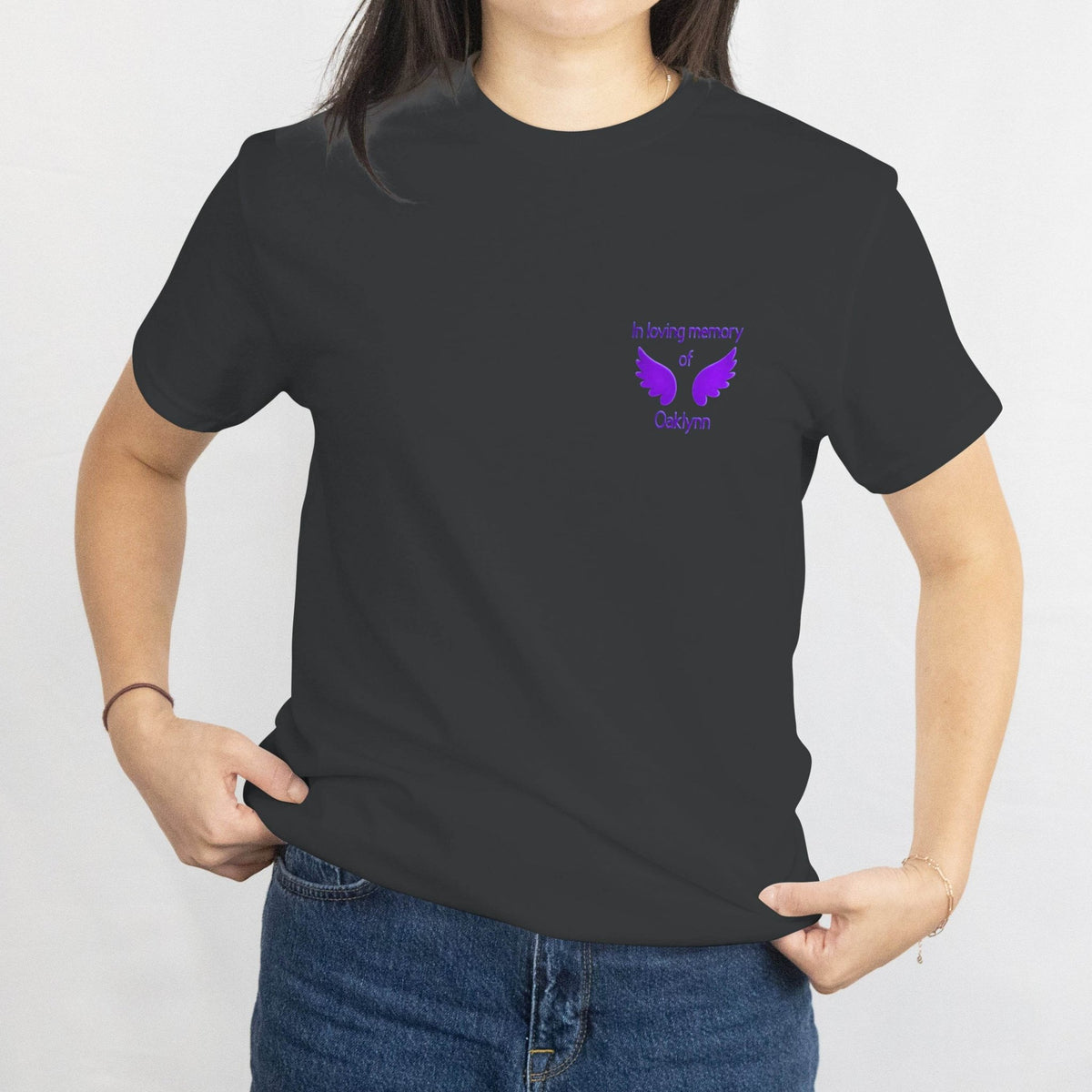 Custom memorial T-shirt with purple dove emblem on chest reading In loving memory of Oaklynn.