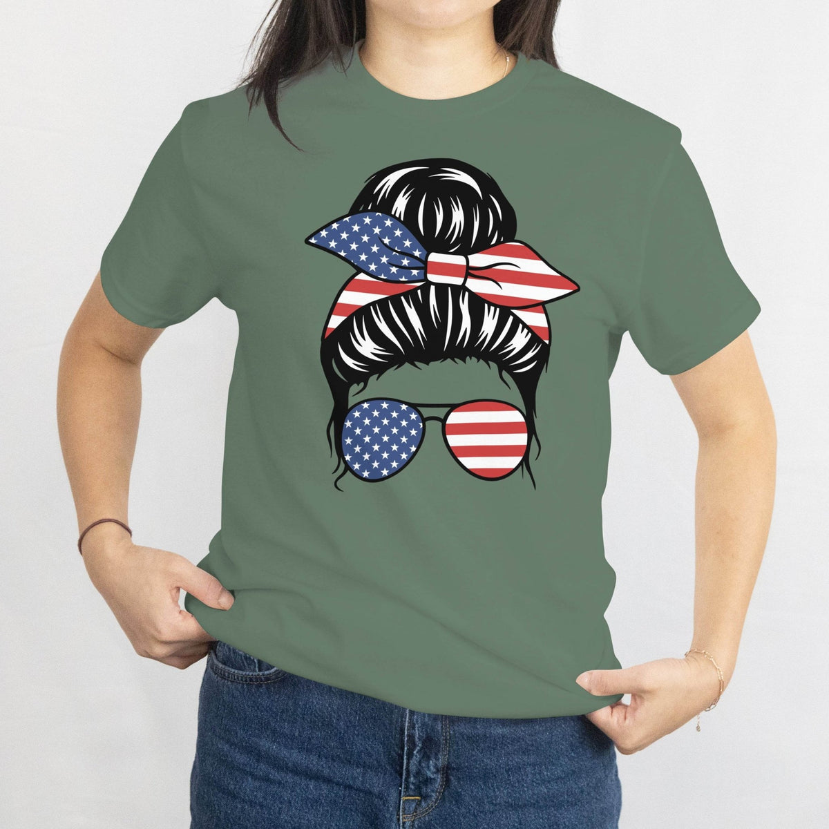 Green Gildan Patriotic Messy Bun T‑Shirt graphic: messy bun with USA flag bandana and round flag sunglasses.