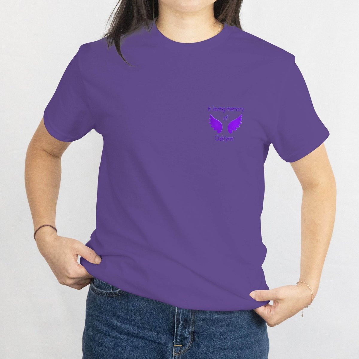 Purple memorial T-shirt with a chest design featuring wings and the text 'in loving memory of Oaklyn'.