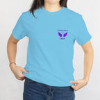 Light blue T-shirt with a purple memorial design on the left chest, 'In loving memory of Oaklynn' with wings.