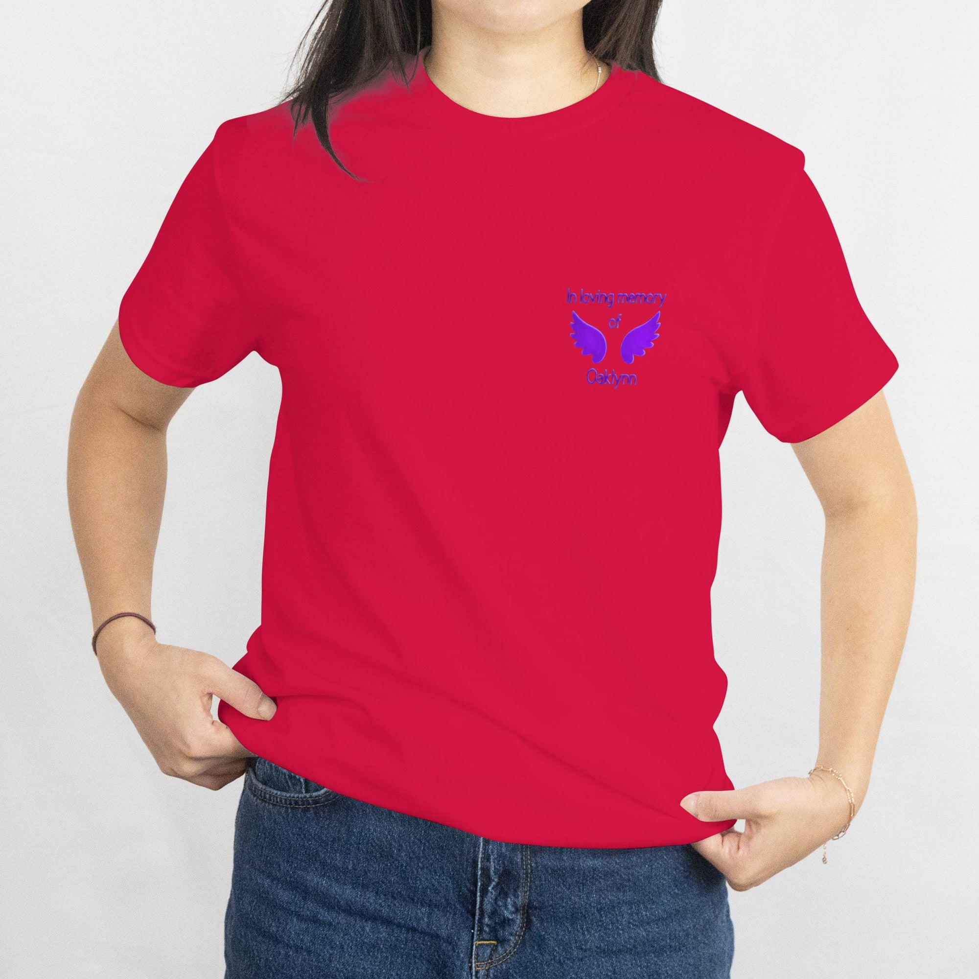 Red T-shirt with small blue wings memorial design on left chest reading In loving memory of Oaklynn.