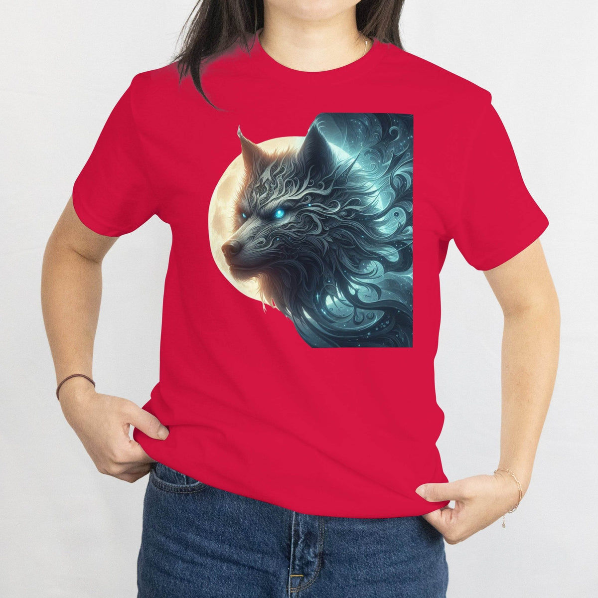 Person wearing a red t-shirt with a graphic of a wolf and moon design.