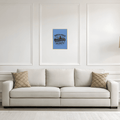 Beige sofa with decorative pillows in a room with a framed poster on the wall.