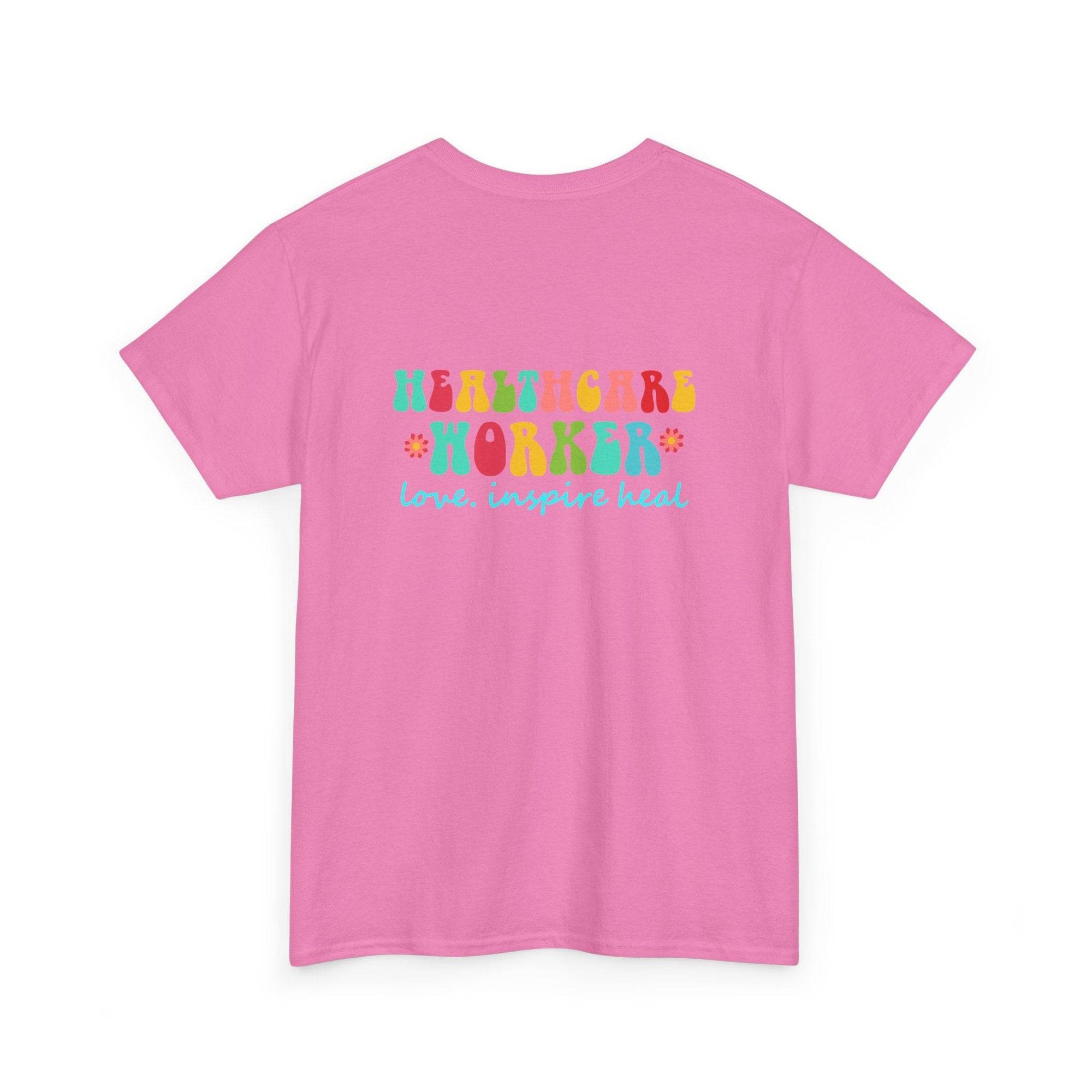 Pink healthcare worker T-shirt with bright multicolor lettering that reads Healthcare Worker and blue 'love, inspire heal' script.