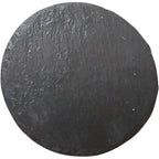 Round black slate coaster with textured surface for bar use.