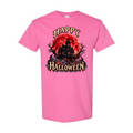 A pink short-sleeve crewneck t-shirt featuring a graphic print of a haunted house in front of a red full moon with the words 'HAPPY HALLOWEEN' in a stylized font.