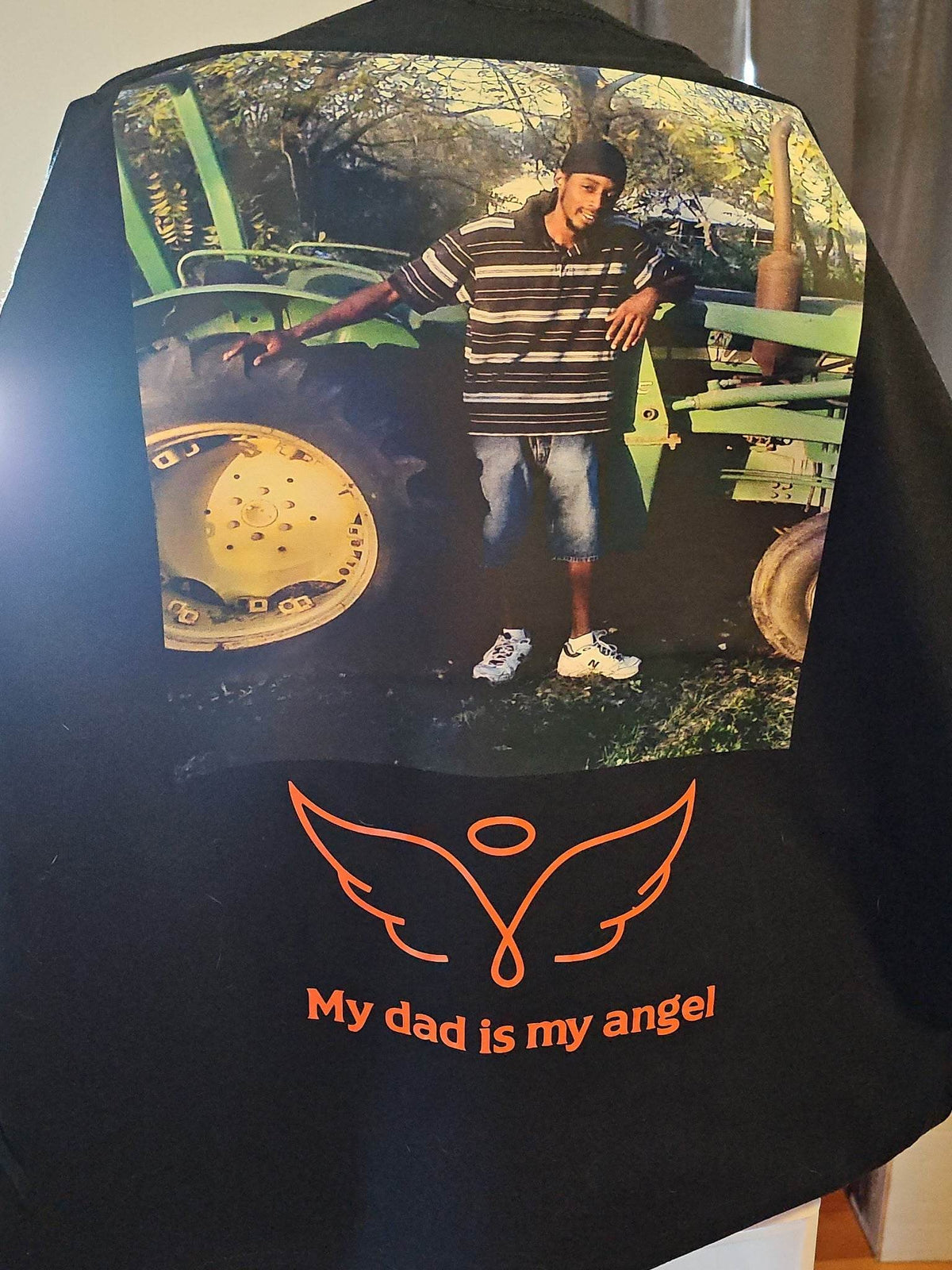 Custom memorial t-shirt with full-color back design: photo, name, dates, angel wings and halo, reads 'My dad is my angel'.