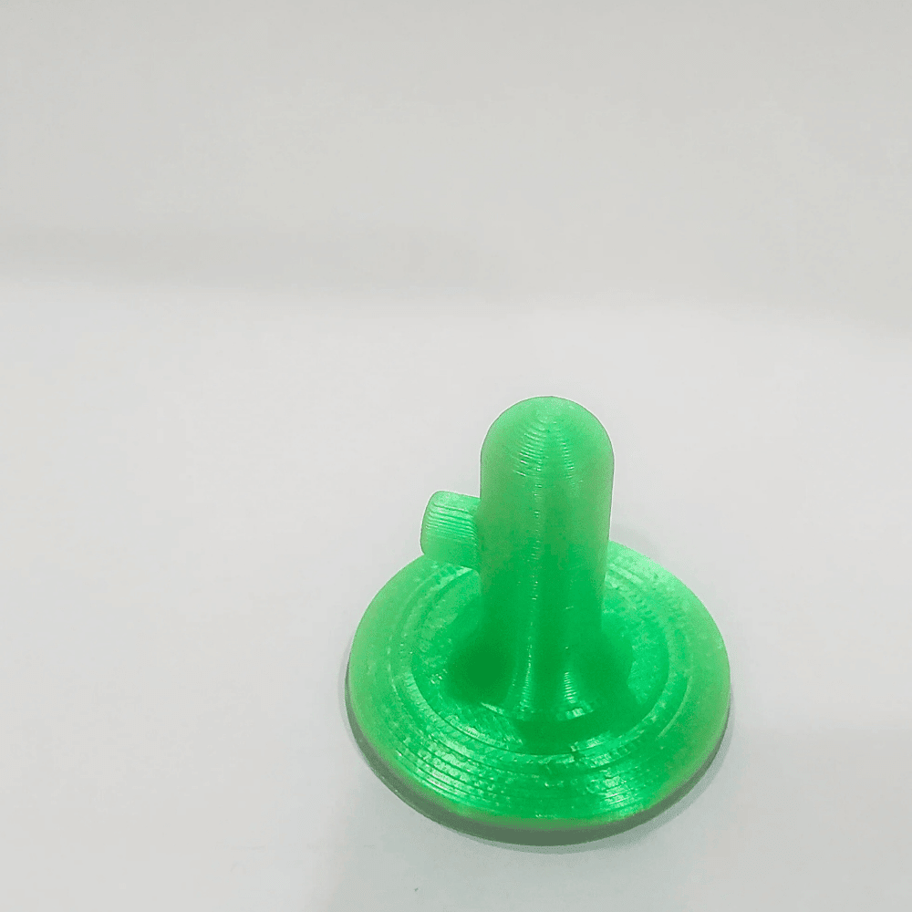 Green 3D-printed object on a white background