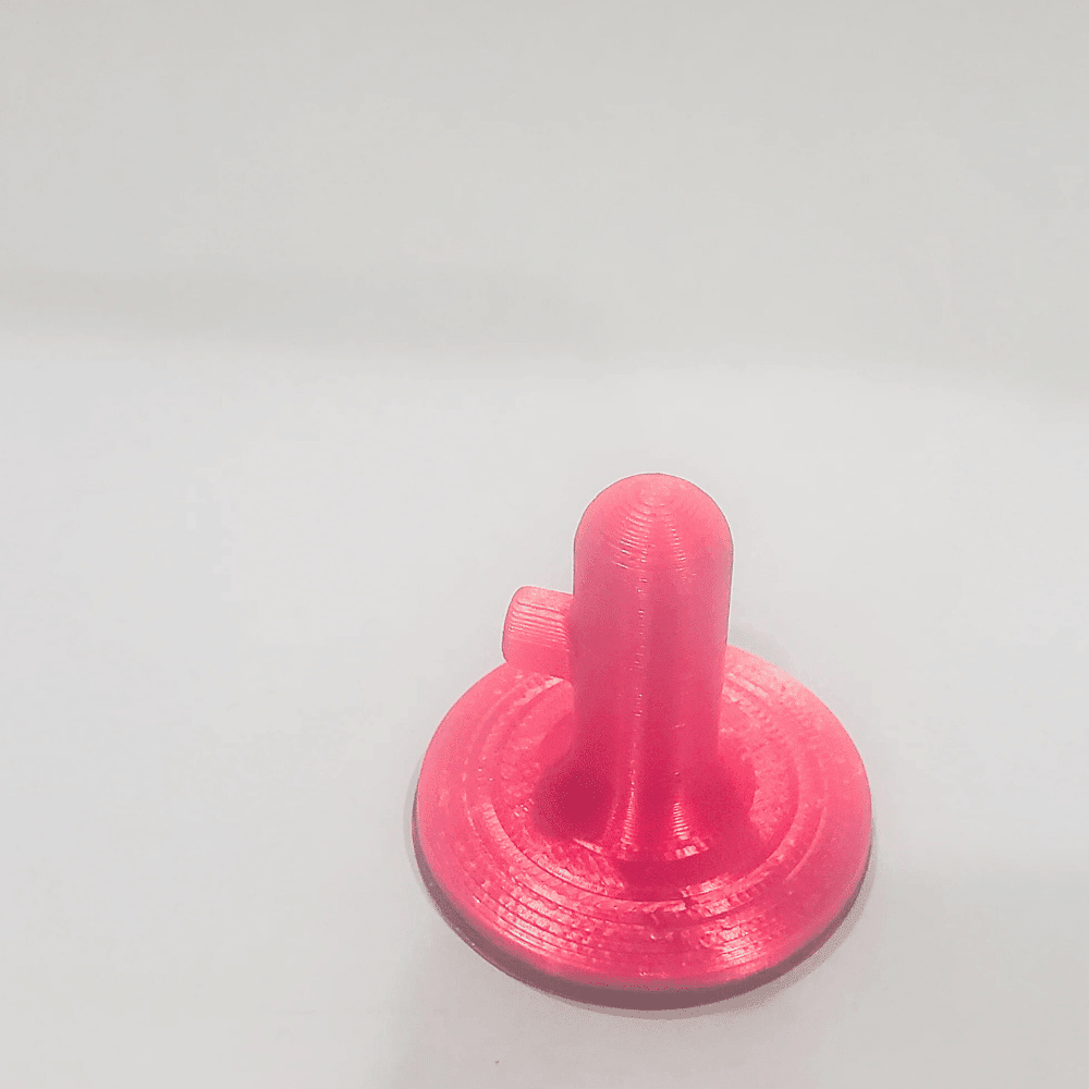 Pink 3D-printed object on a light gray background