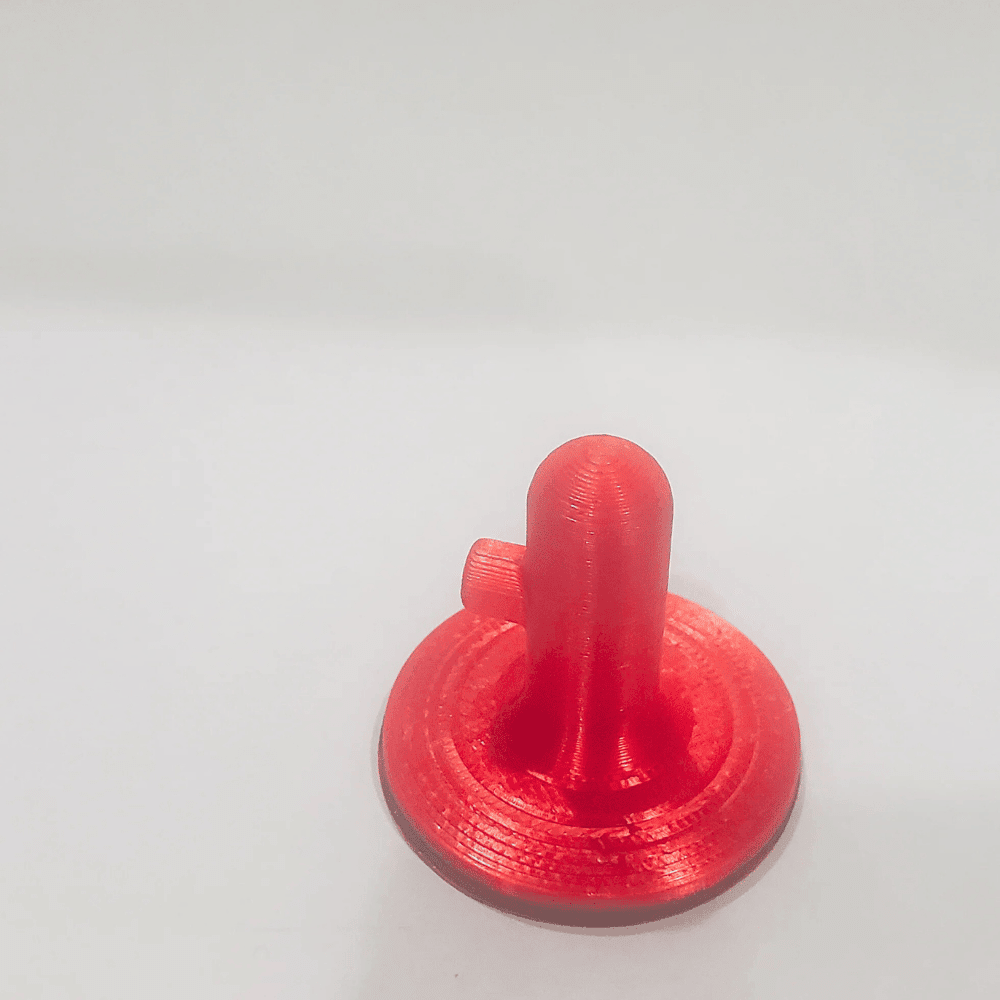 Red 3D-printed object on a white background