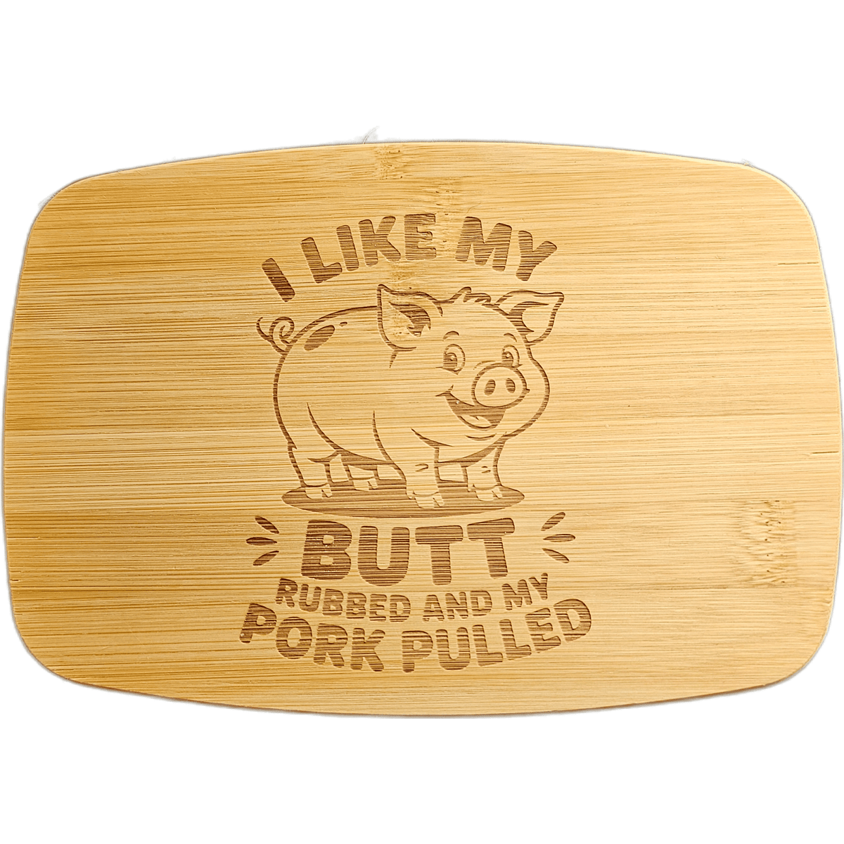 A rectangular bamboo cutting board with rounded corners, featuring a laser-engraved cartoon pig and the humorous phrase 'I LIKE MY BUTT RUBBED AND MY PORK PULLED'.