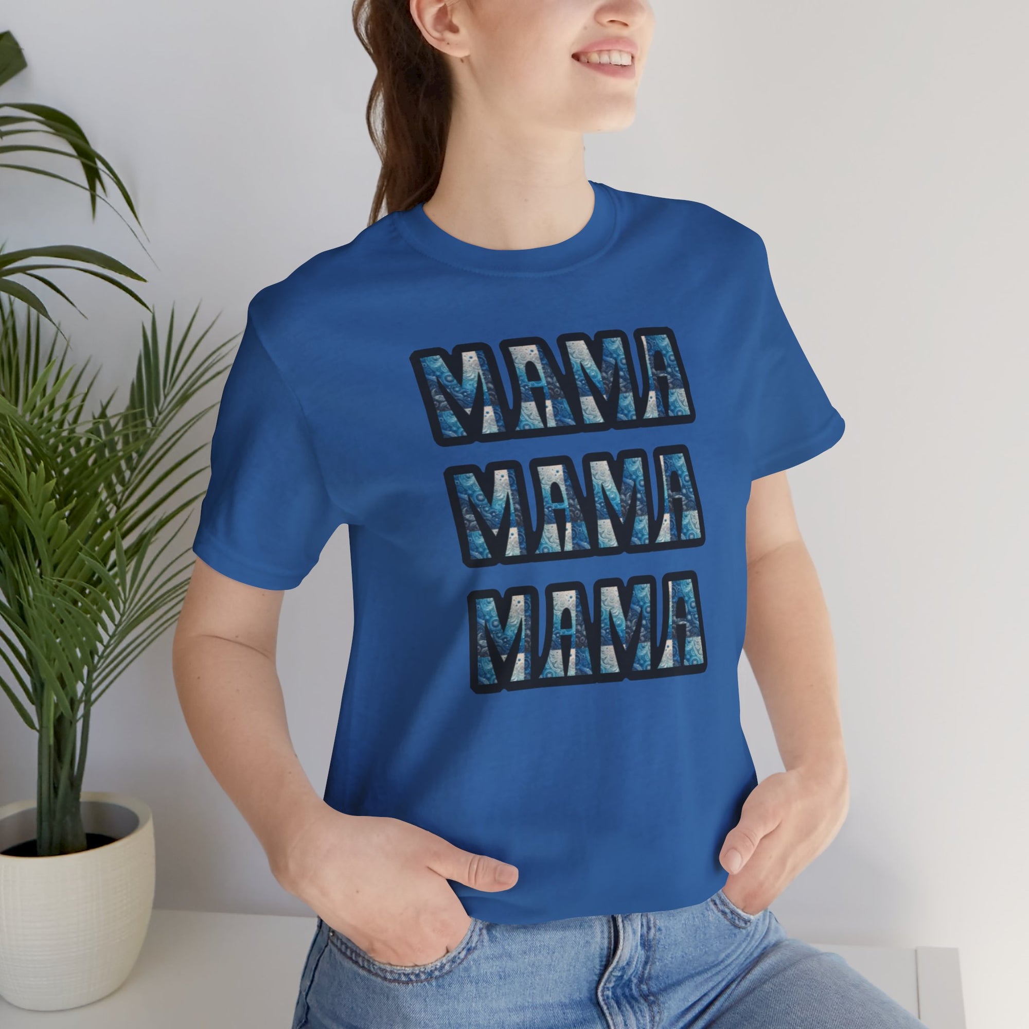 Blue Mama Mama Mama graphic tee with triple MAMA lettering worn by a woman in jeans.