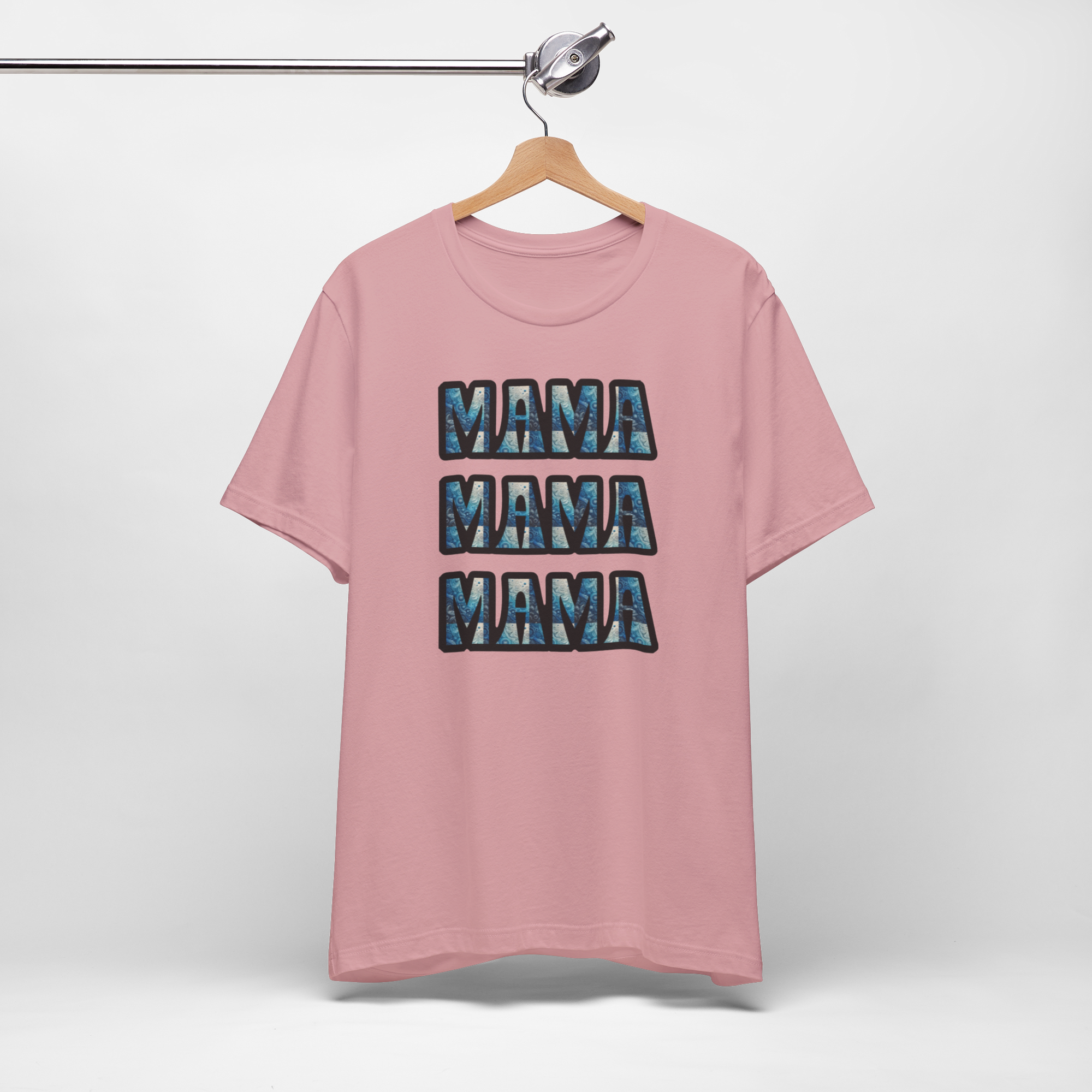 Pink Mama Mama Mama graphic T-shirt on hanger with three stacked blue-patterned MAMA text.