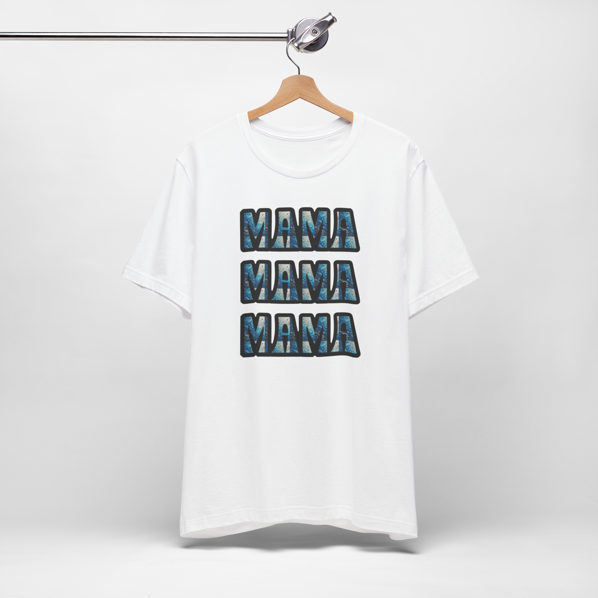 White Mama Mama Mama graphic T-shirt on hanger with four stacked blue MAMA blocks (Bella Canvas 3001 style).