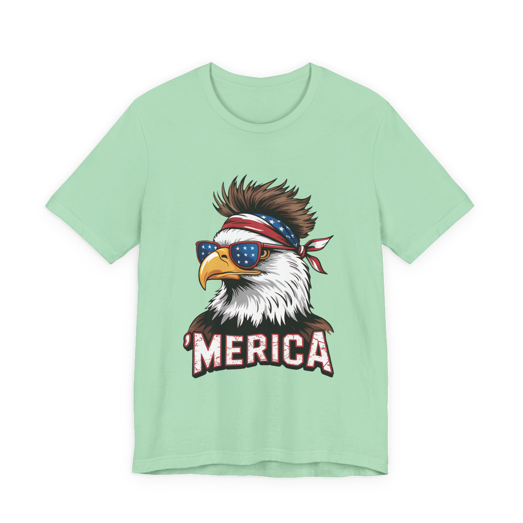 Mint green unisex tee with bold eagle graphic wearing star-spangled sunglasses and bandana, MERICA text.