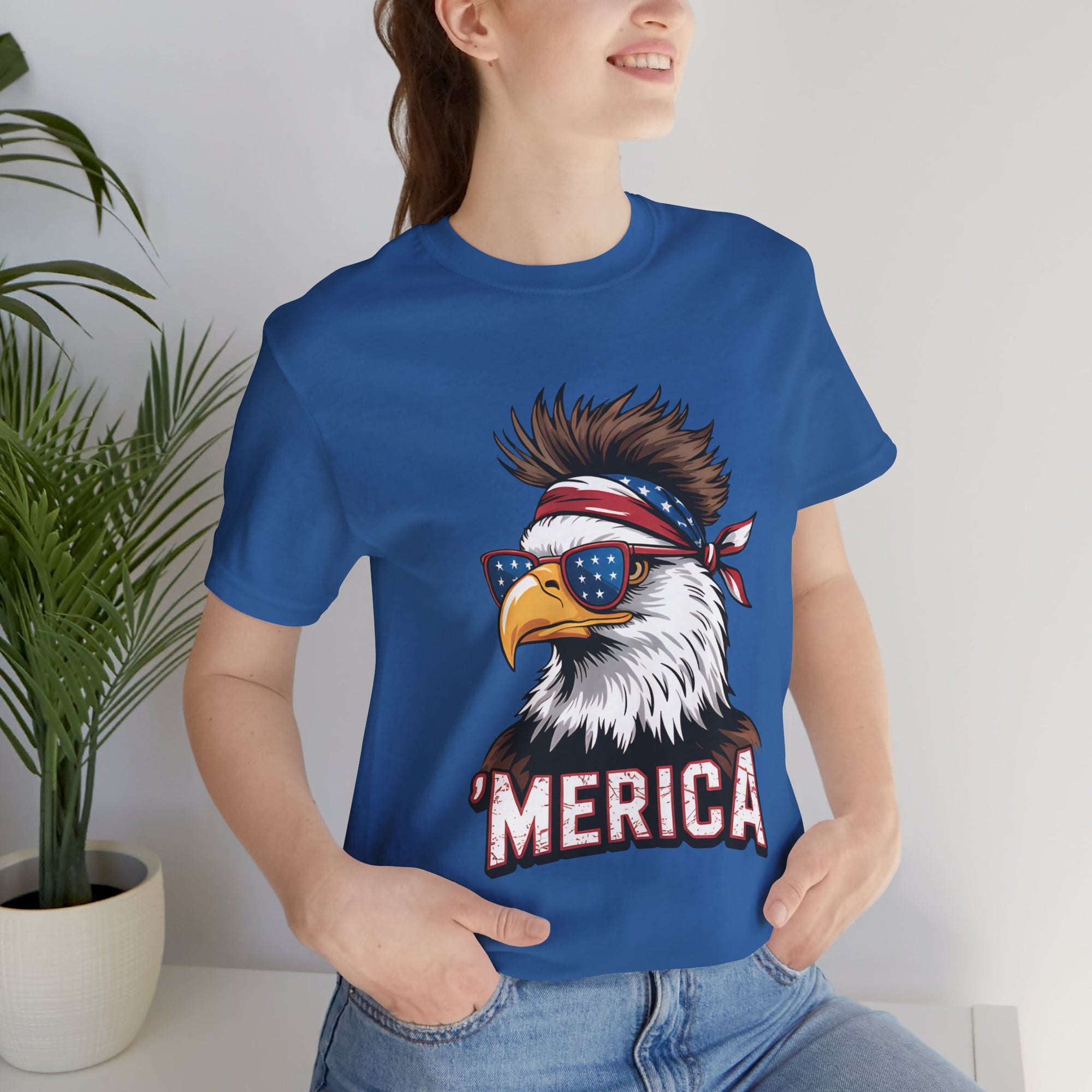 Blue T-shirt with a bold eagle wearing star-spangled sunglasses and a bandana, 'MERICA' graphic.