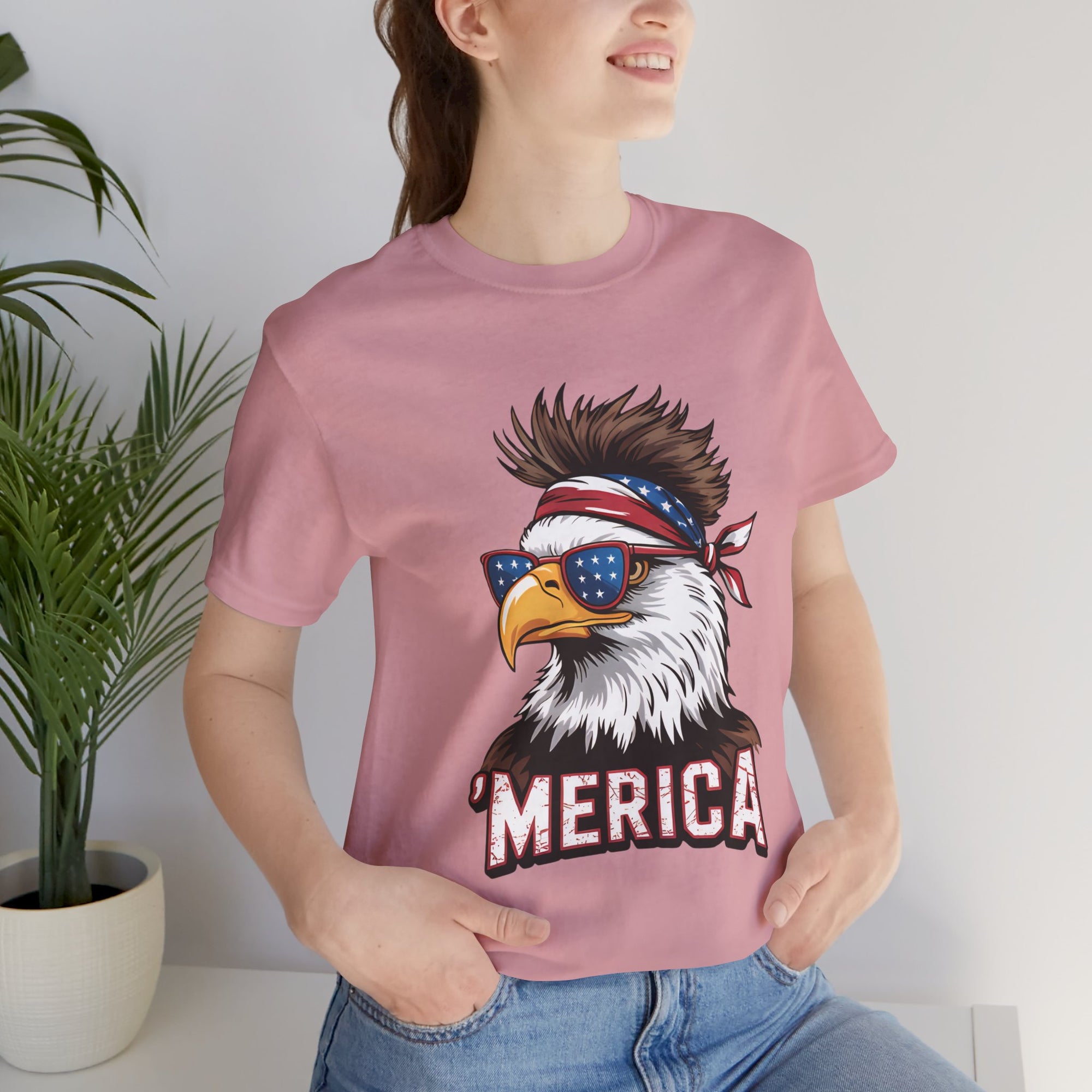 Pink Merica Eagle Bella Canvas tee featuring an eagle wearing star-spangled sunglasses and a bandana with 'MERICA'.