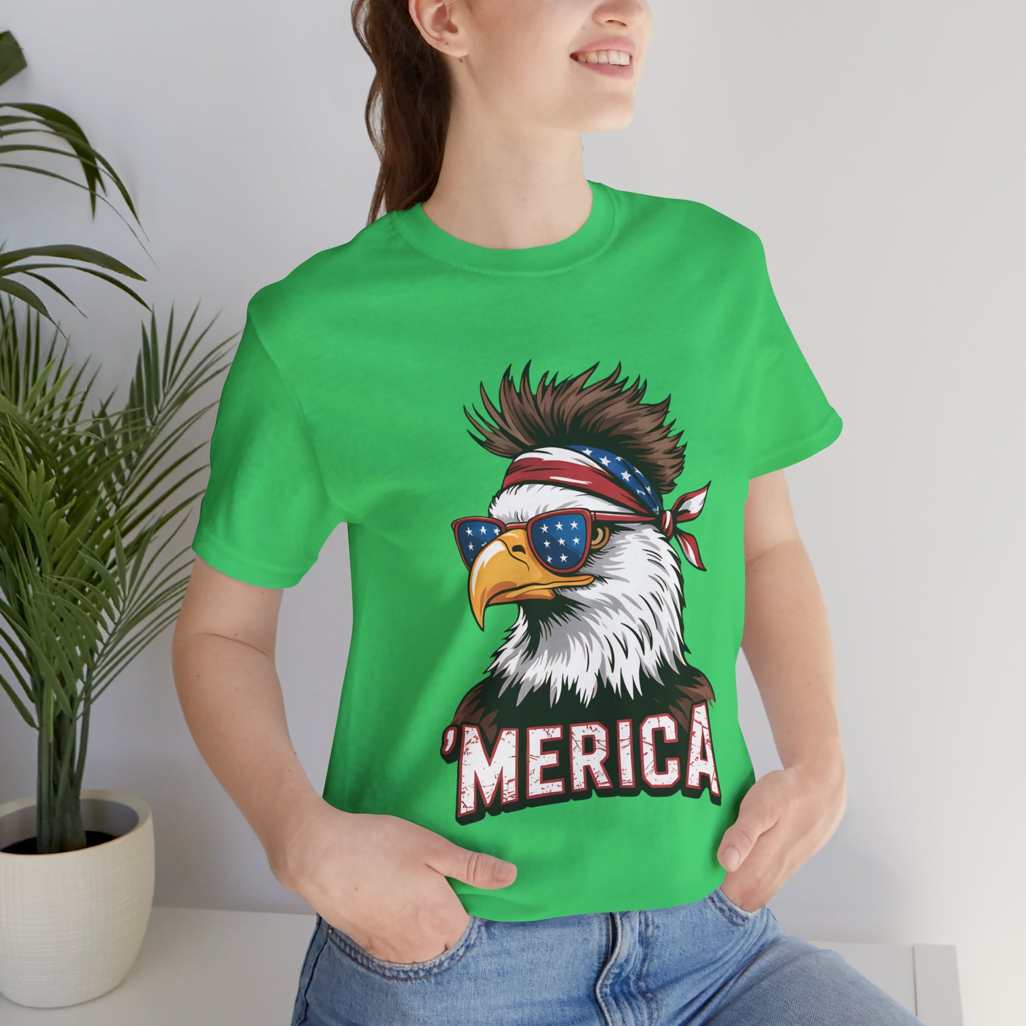 Green graphic tee featuring a patriotic eagle with star-spangled sunglasses and a red bandana MERICA text.