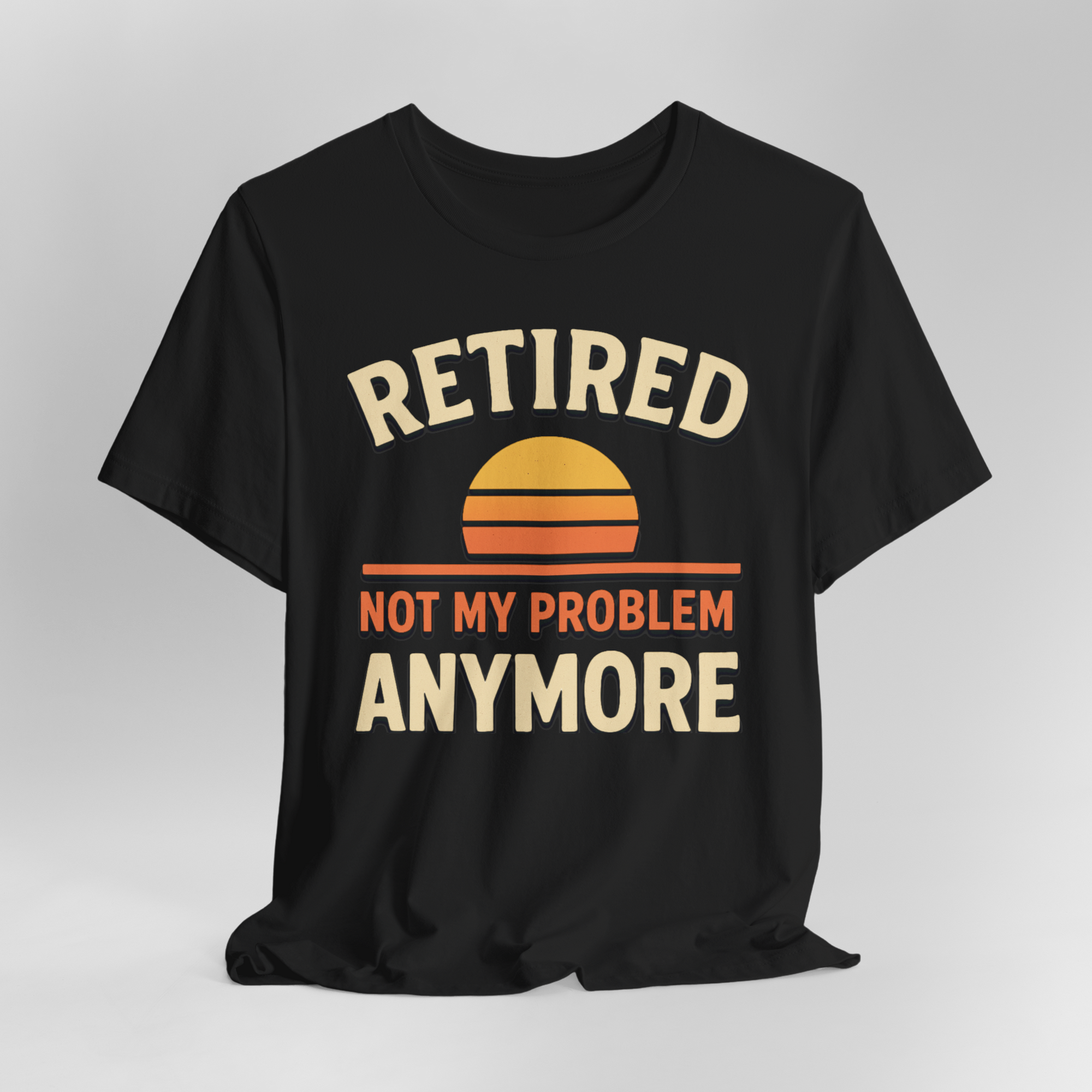 Black T-shirt with retro sunset graphic and bold text: Retired not my problem anymore.