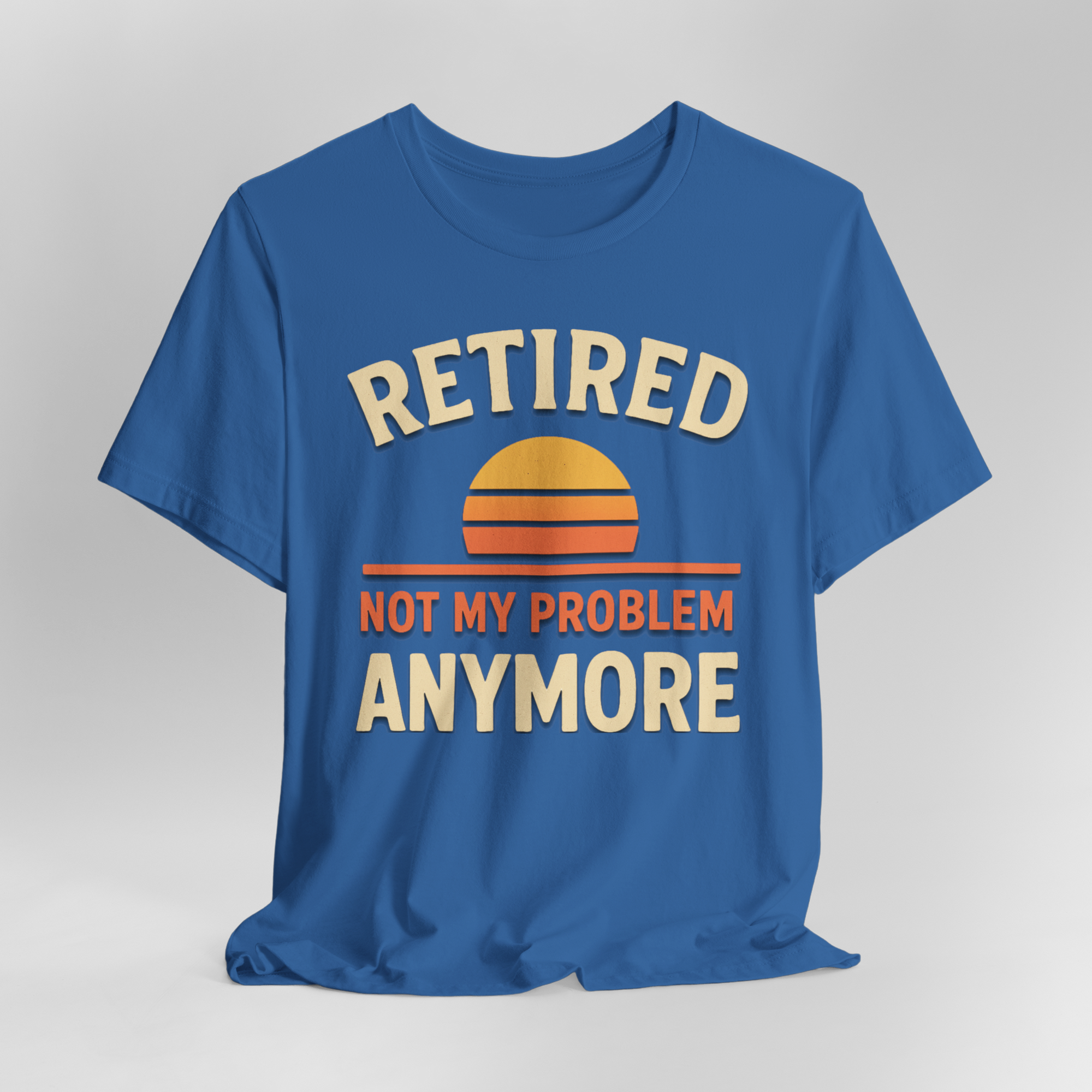 Blue T-shirt with a sunset graphic and the slogan Retired Not My Problem Anymore.