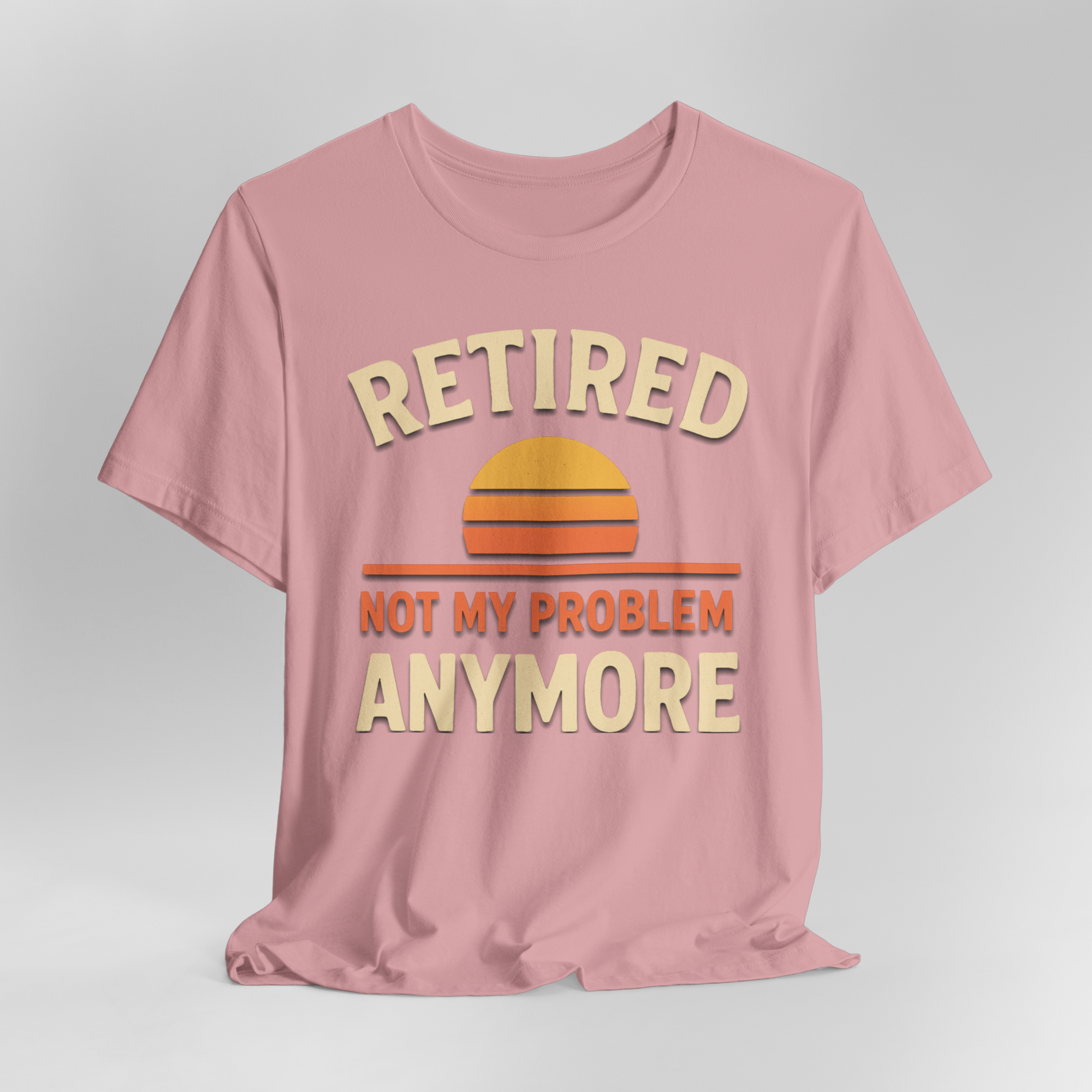 Pink T-shirt featuring retro sunset graphic with beige text Retired Not My Problem Anymore.