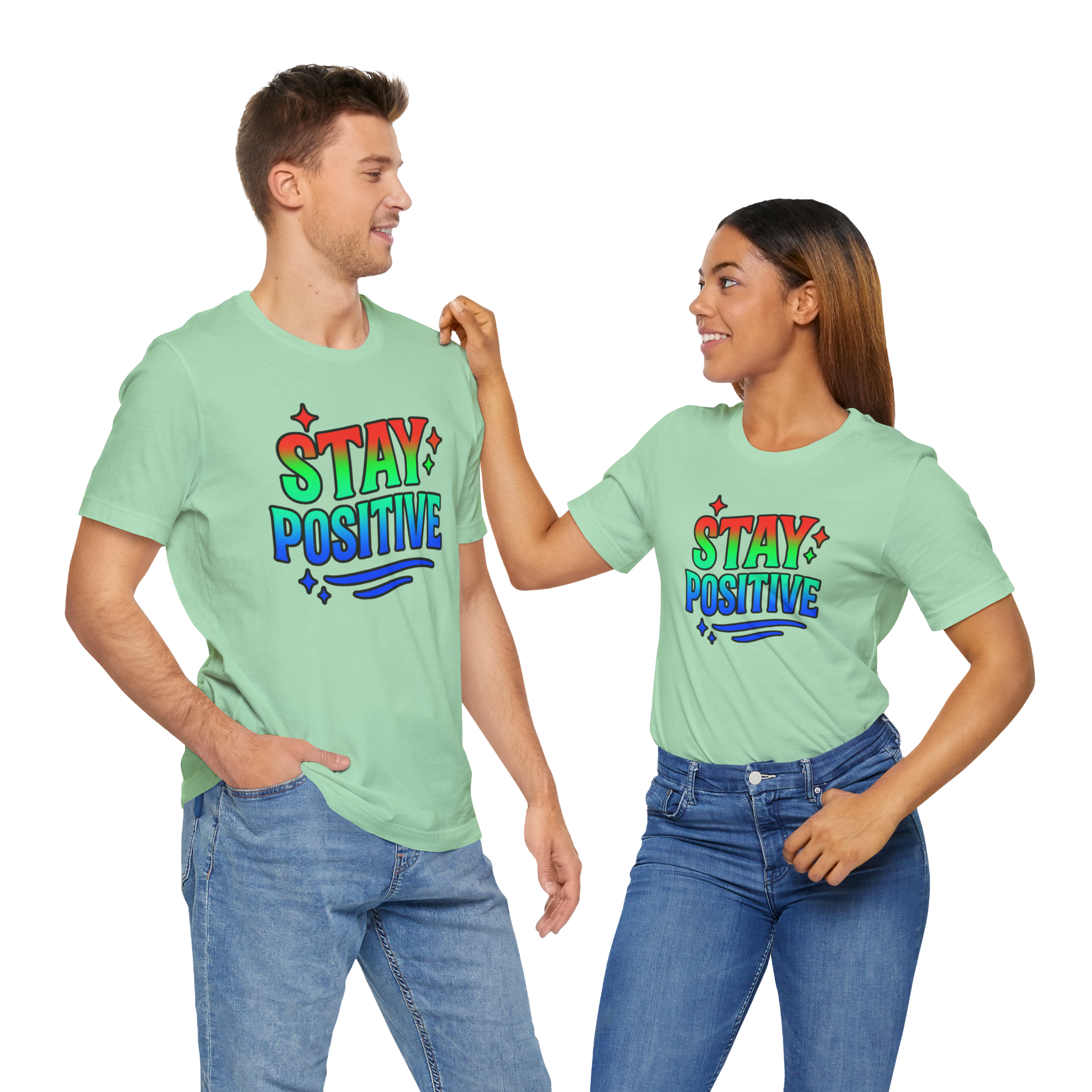 Two people in mint green Stay Positive T-shirts, smiling at each other in jeans.