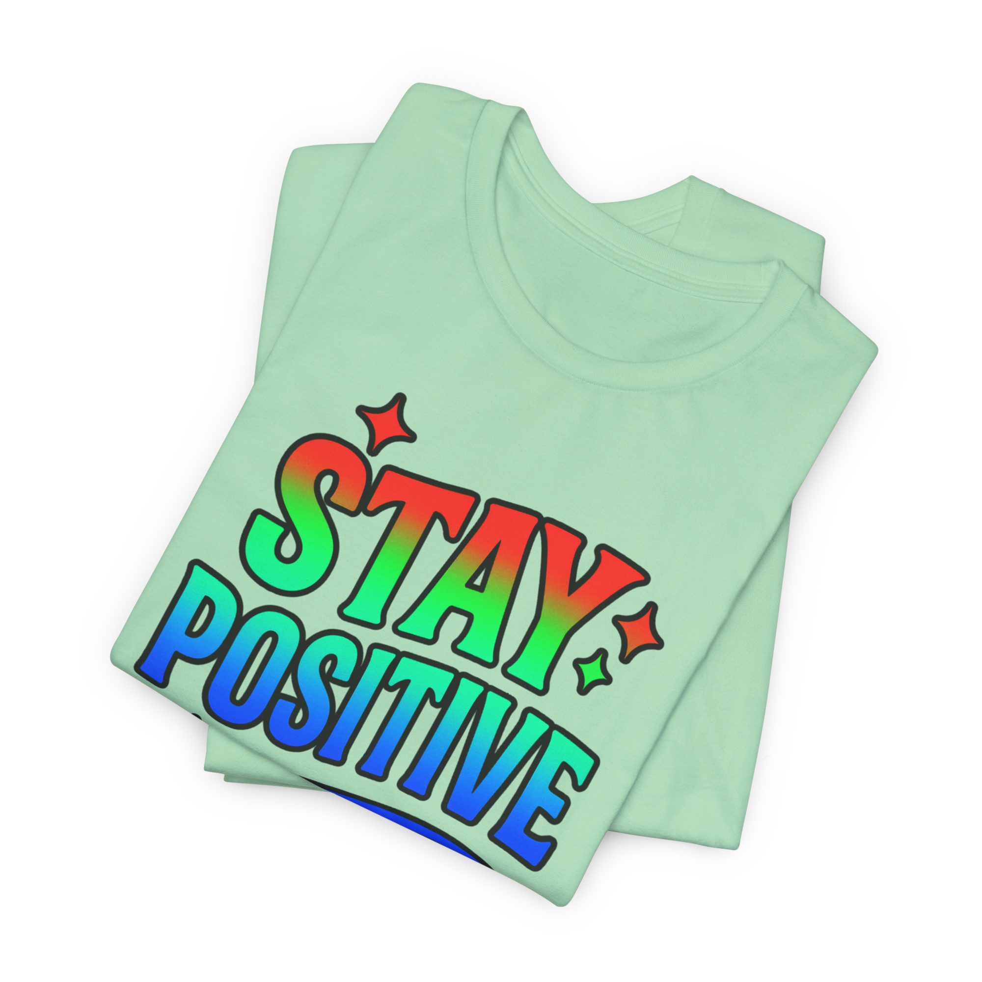 Mint green Stay Positive T-shirt with rainbow gradient lettering and star accents.