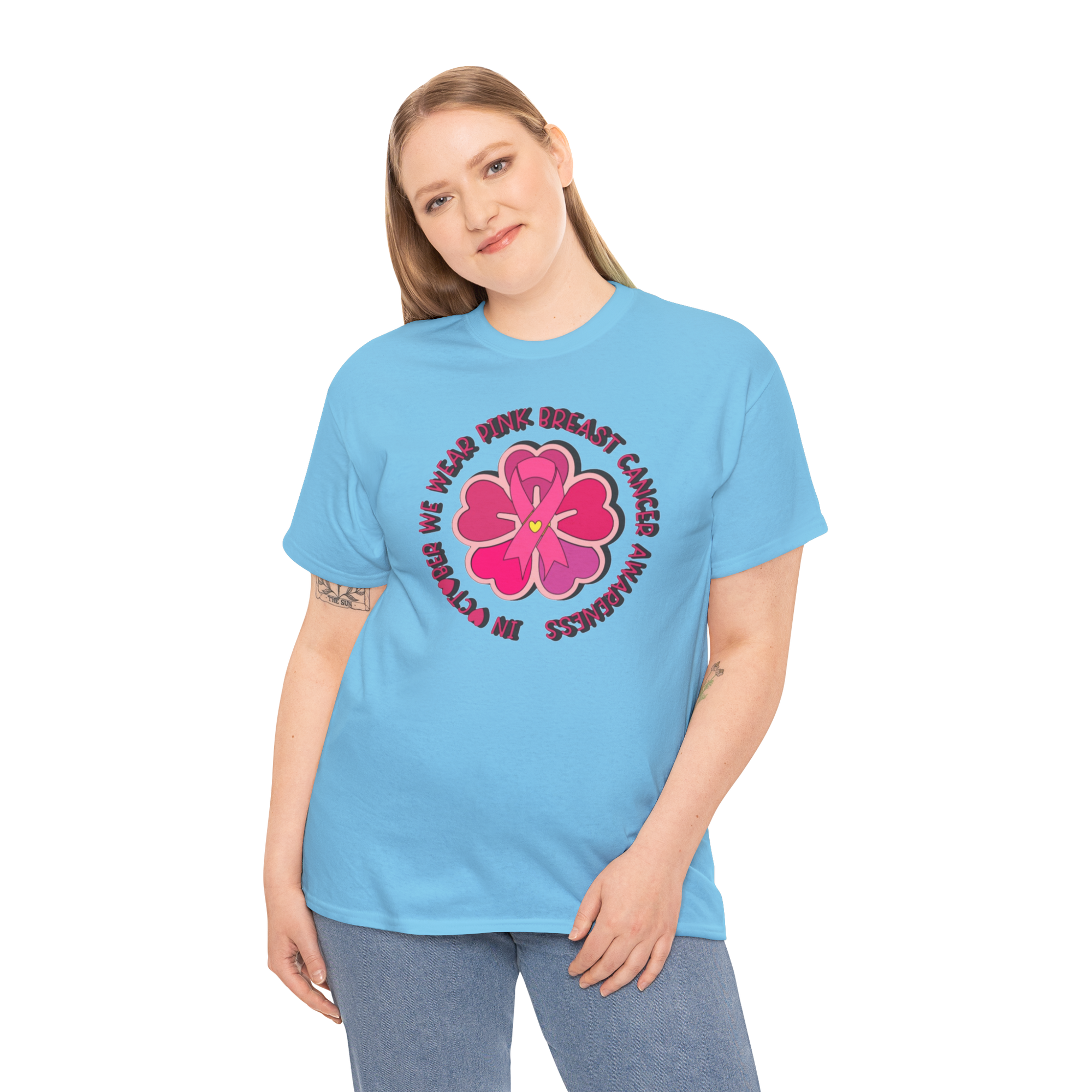 Woman wearing a light blue Gildan 5000 tee with a pink flower breast cancer awareness graphic.
