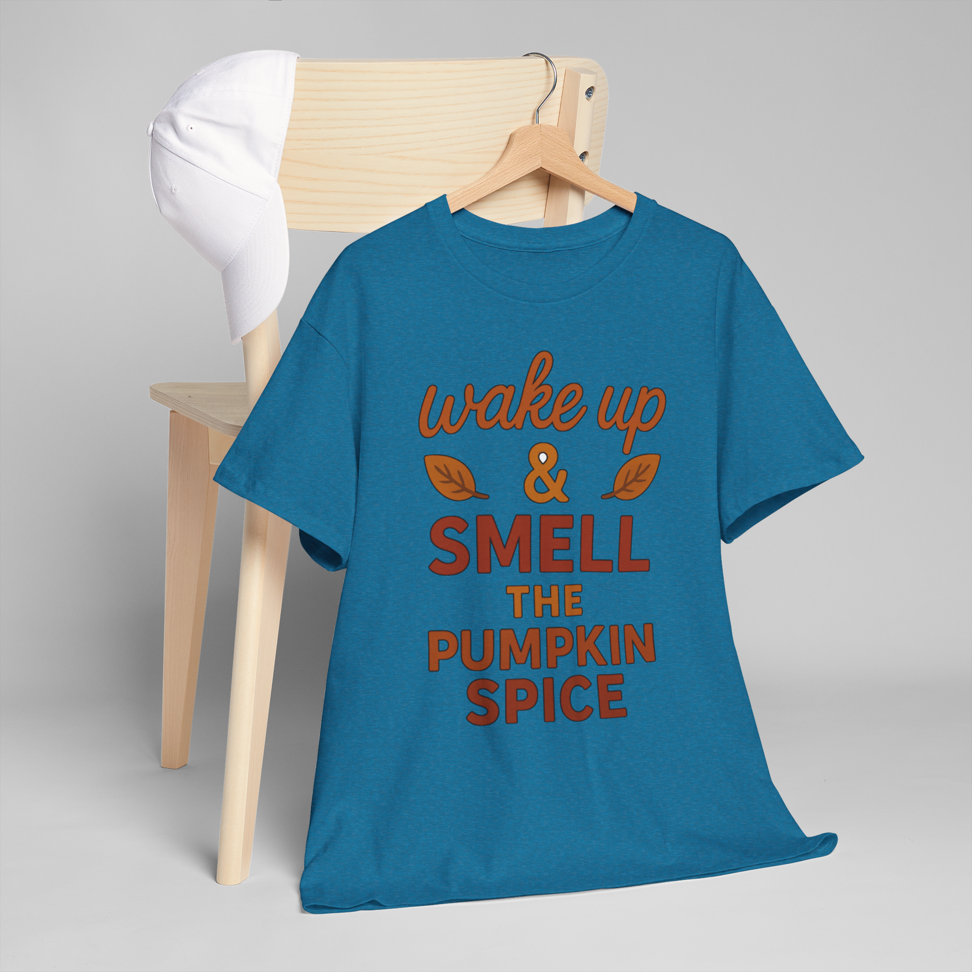Gildan 5000 pumpkin spice blue T-shirt with orange wake up & smell the pumpkin spice slogan on a hanger
