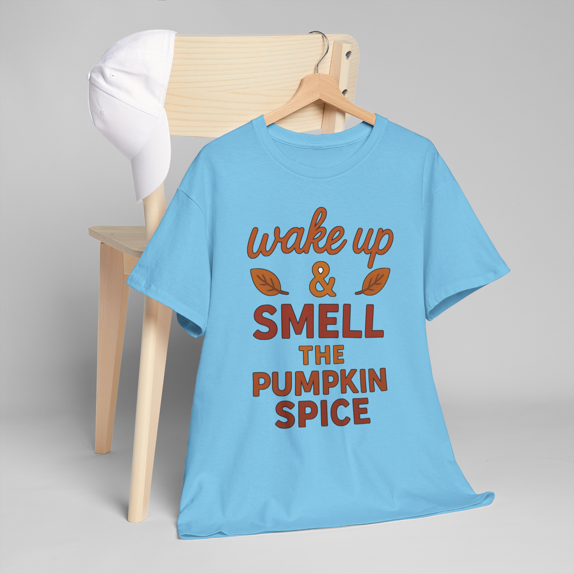 Gildan 5000 pumpkin spice t-shirt on a hanger, light blue with wake up & smell the pumpkin spice graphic.