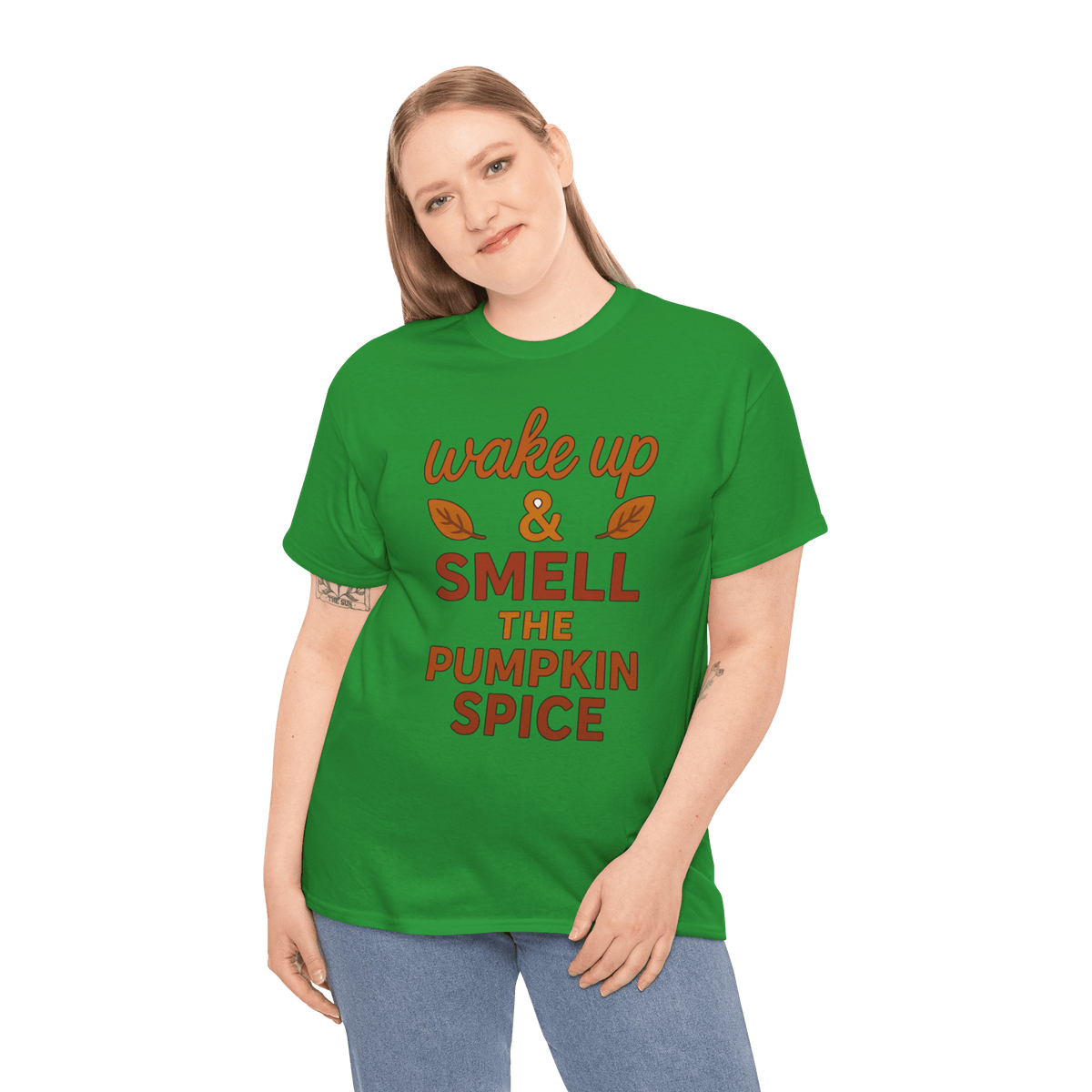 Woman wearing green gildan 5000 pumpkin spice T-shirt that reads 'wake up & smell the pumpkin spice' with leaf graphics.