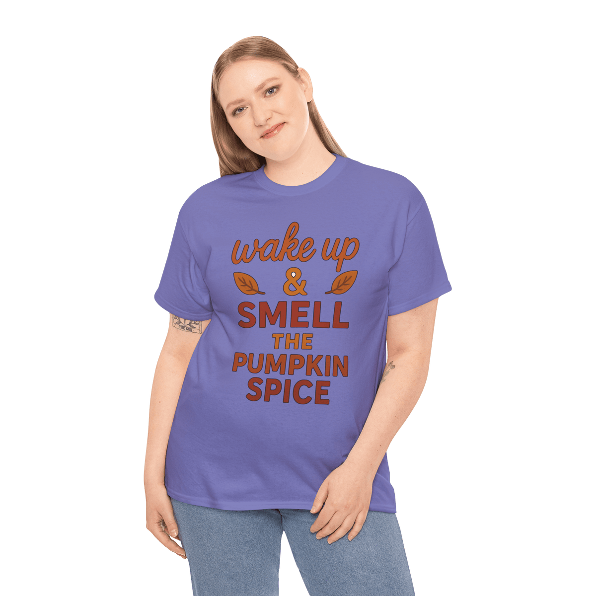 Woman in purple gildan 5000 tee with orange text wake up & smell the pumpkin spice and leaf graphics.