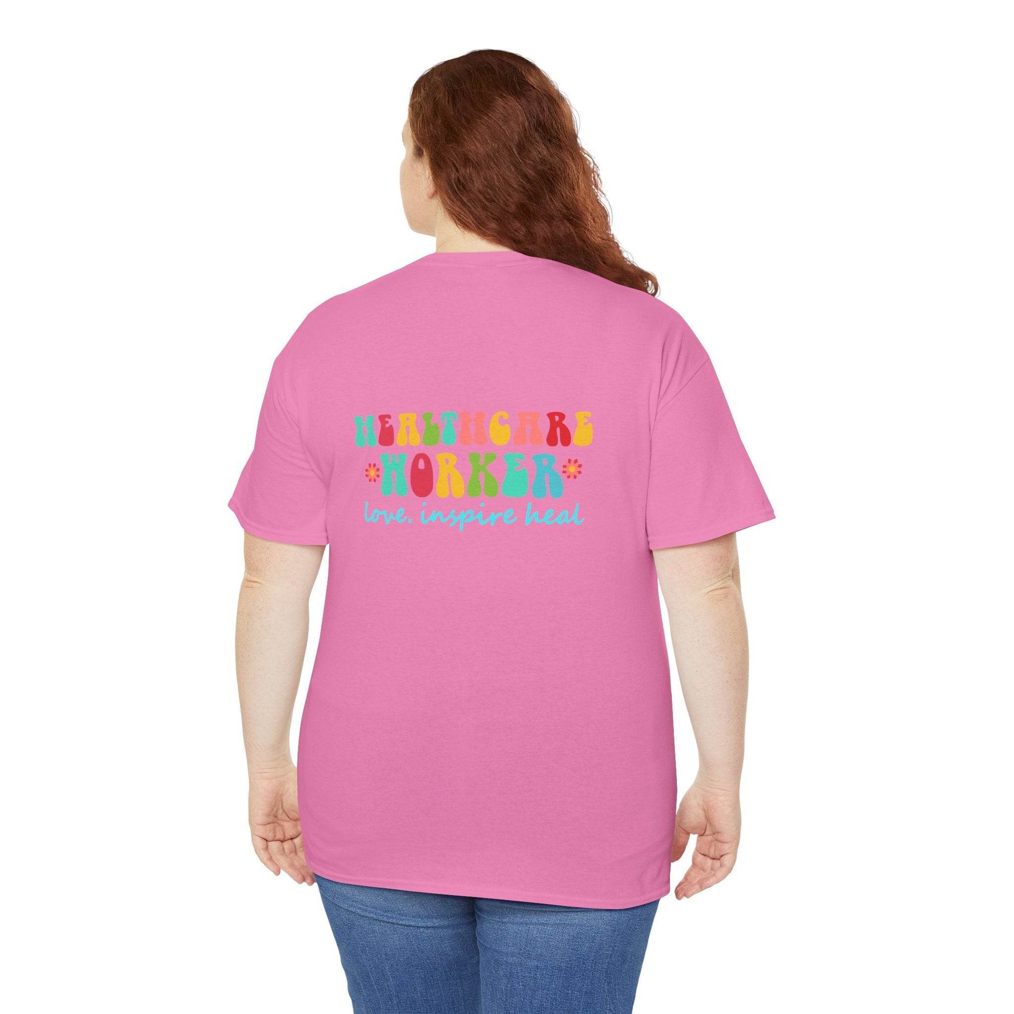 Pink healthcare workers T-shirt with multicolored 'Healthcare Worker' graphic and 'love, inspire heal' on back.