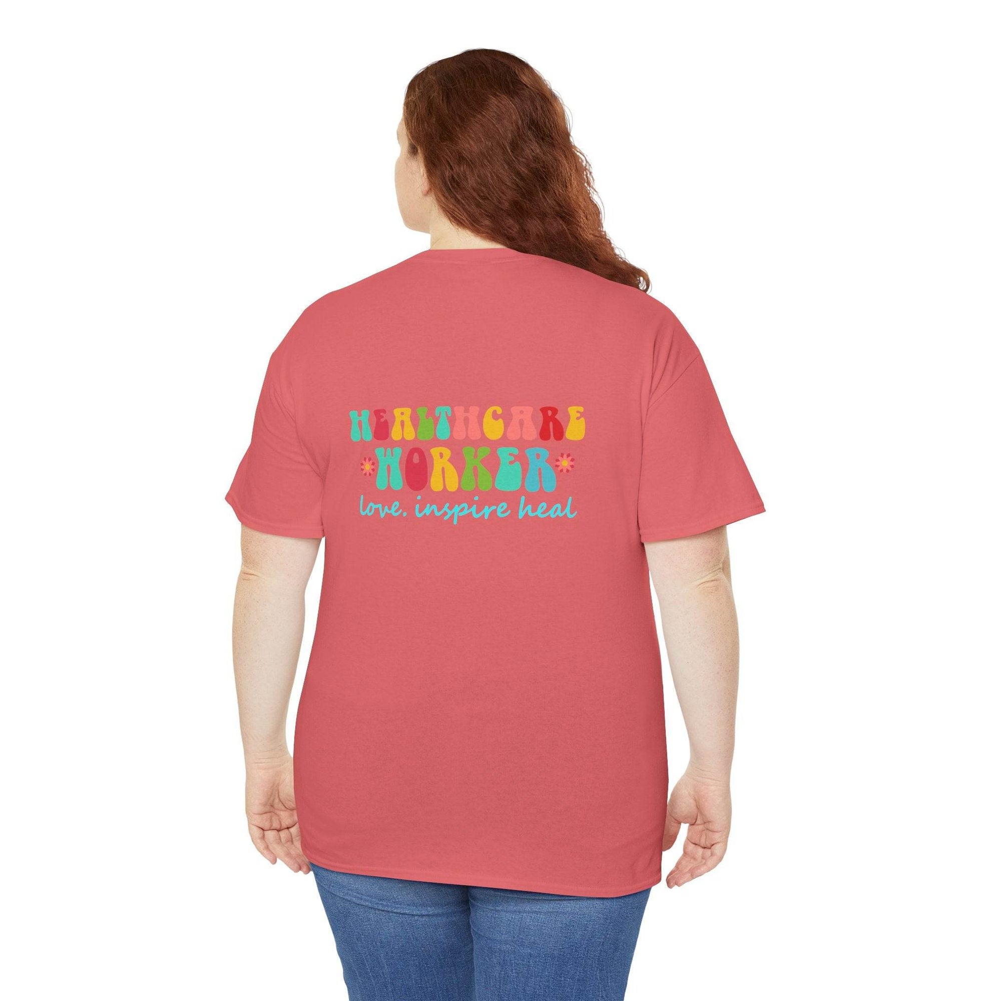 Back view of a pink T-shirt featuring a colorful Healthcare Worker graphic and the love inspire heal slogan.