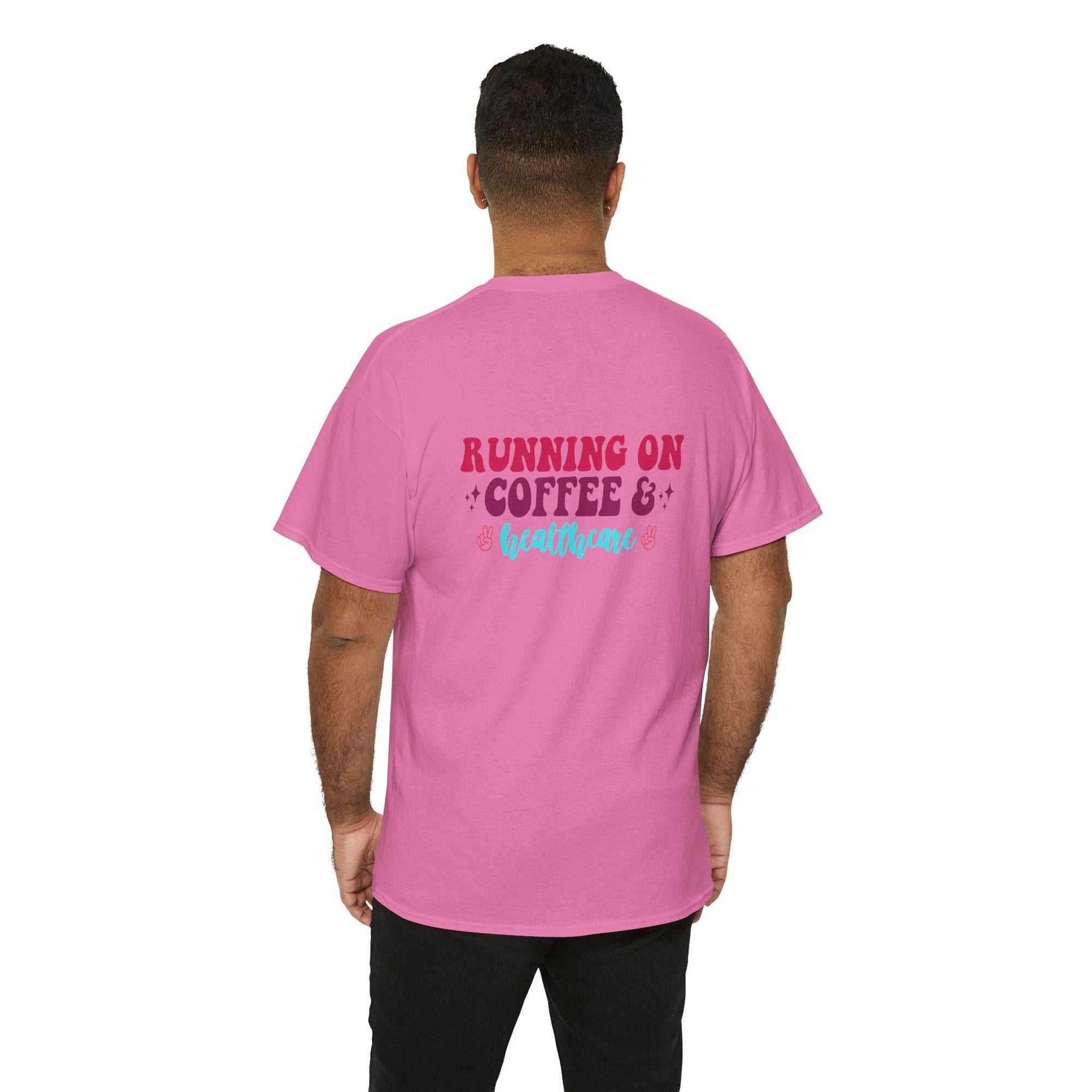Back view of a pink T-shirt with the text RUNNING ON COFFEE & healthcare in red and turquoise.