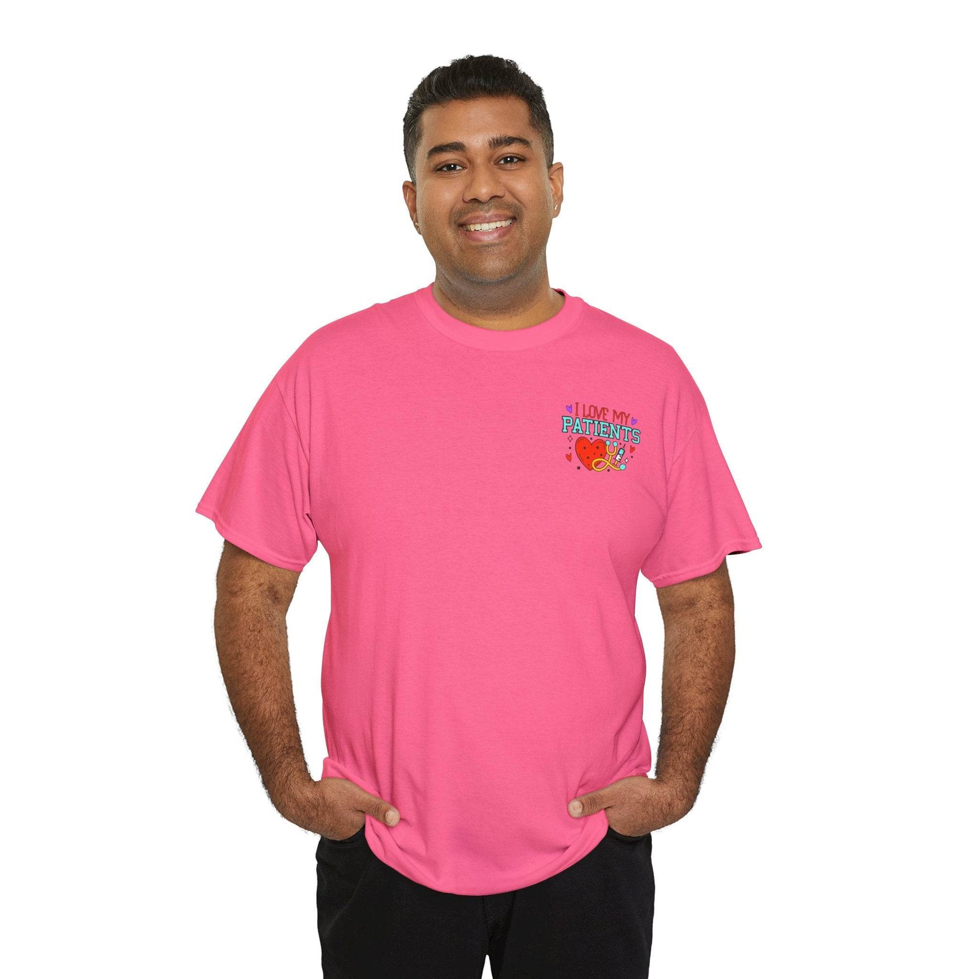 Smiling man in pink healthcare workers T-shirt with chest graphic reading I Love My Patients.