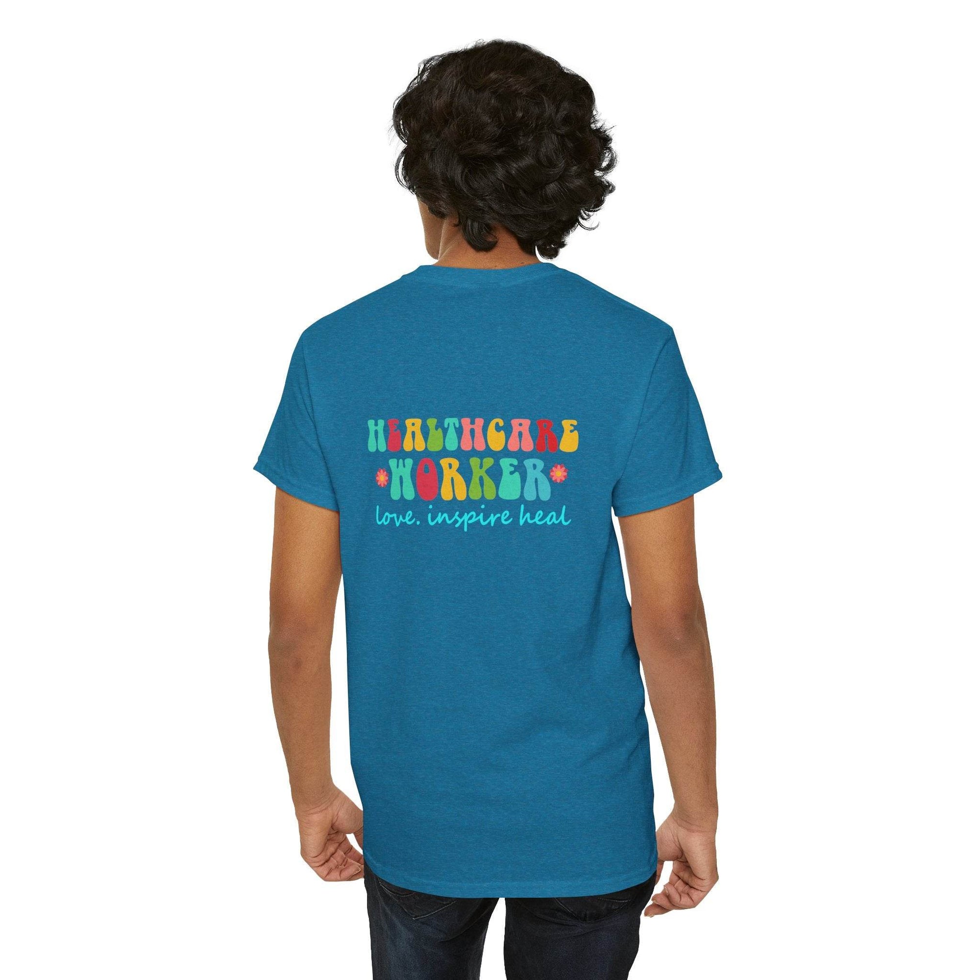 Back view of blue Healthcare Workers T‑Shirt with colorful Healthcare Worker graphic and love inspire heal slogan.