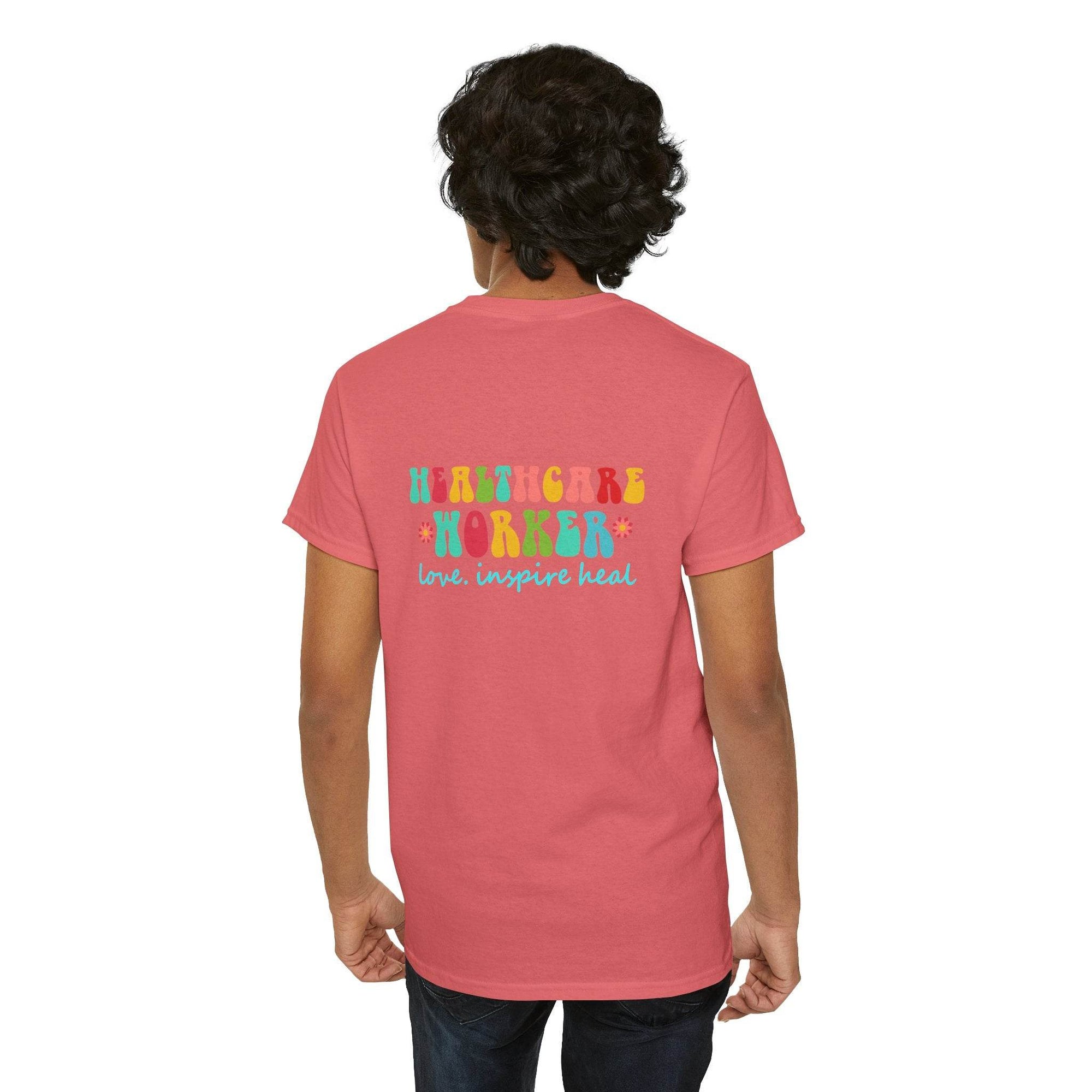 Back view of coral pink Healthcare Workers T Shirt with Healthcare Worker graphic and love inspire heal slogan.