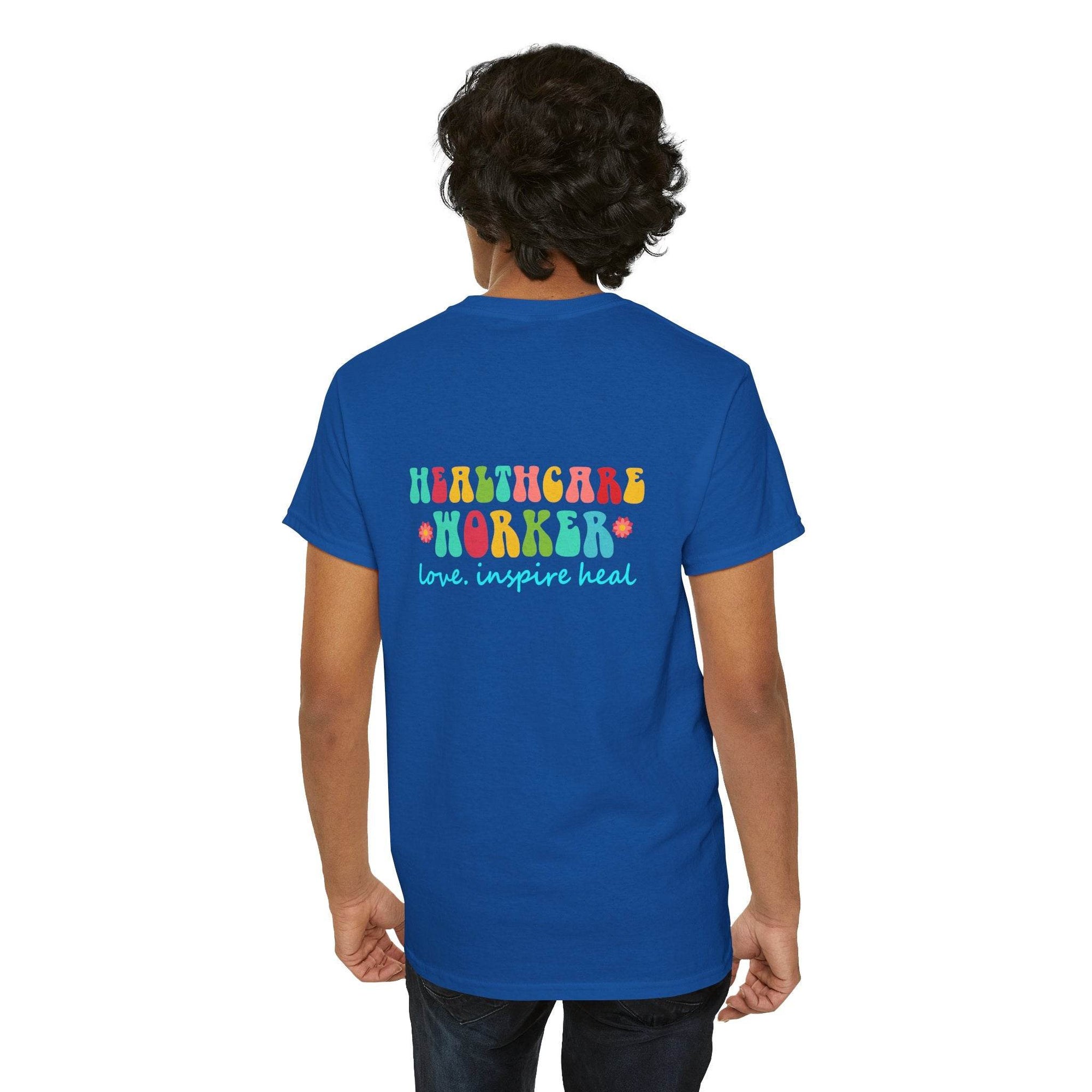 Blue healthcare worker T-shirt back view with colorful Healthcare Worker text and love inspire heal slogan.