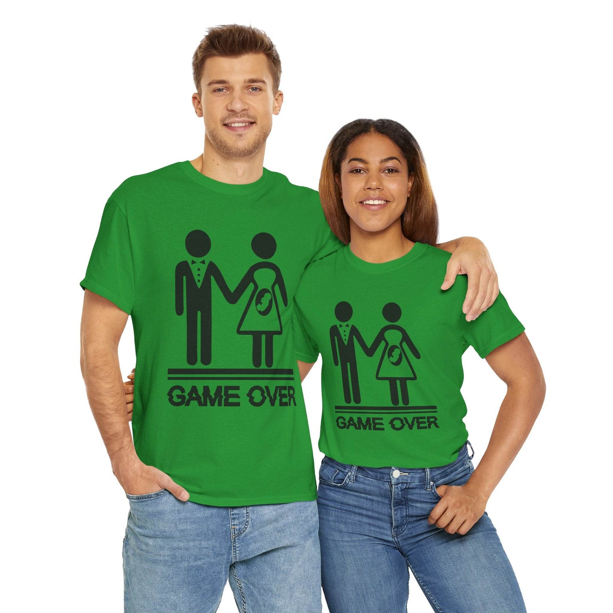 Couple wearing green Game Over tees (Gildan 5000) with wedding stick-figure couple and baby-on-board icon.