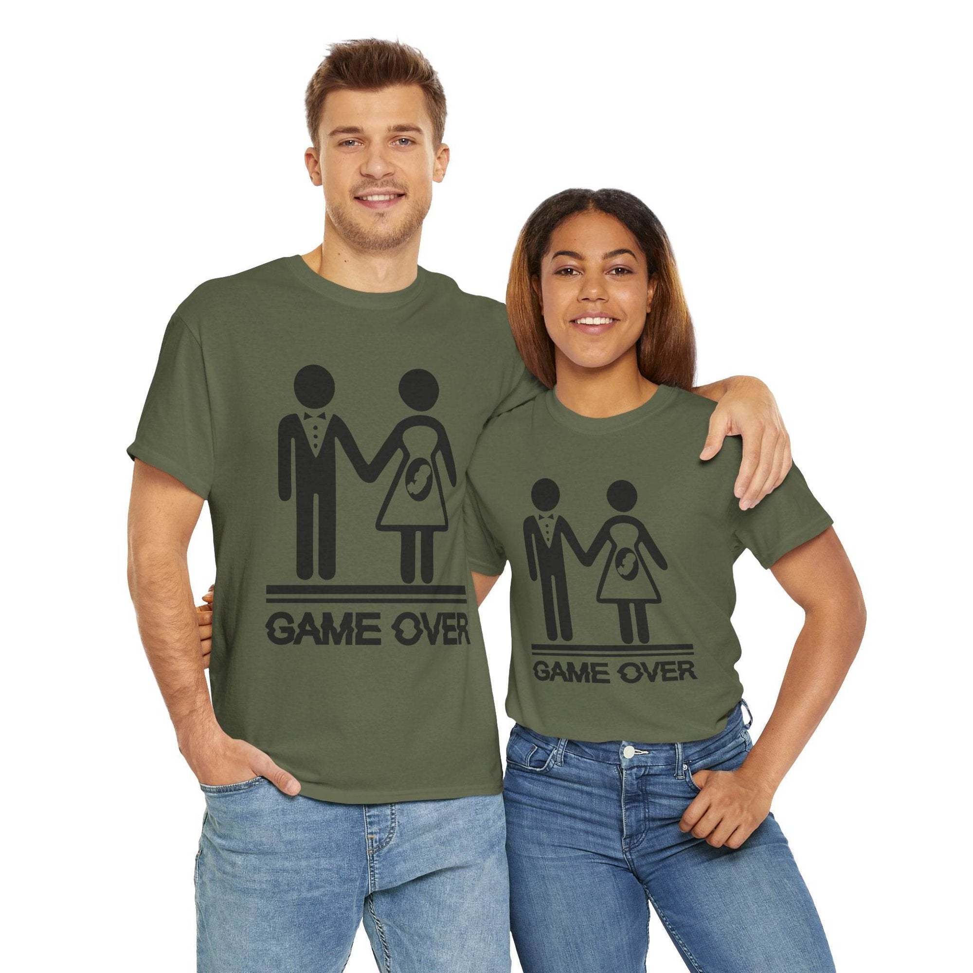 Couple wearing Game Over wedding and pregnancy reveal tees featuring stick figures and baby icon.