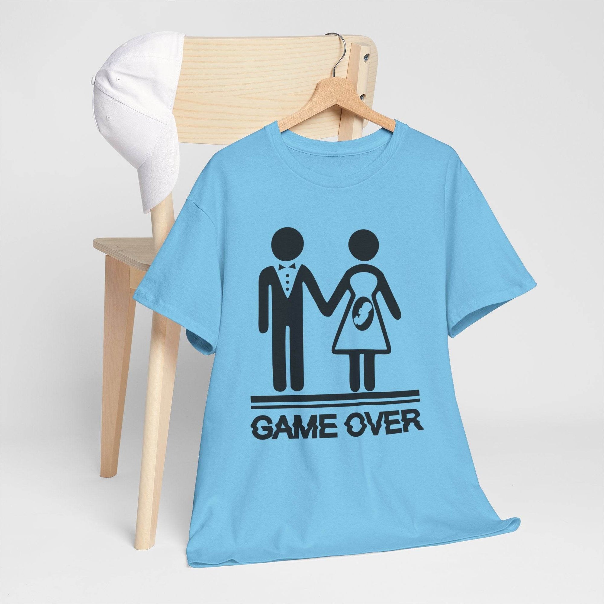 Blue Gildan 5000 T-shirt with Game Over design: stick-figure couple, baby bump icon, and GAME OVER text.